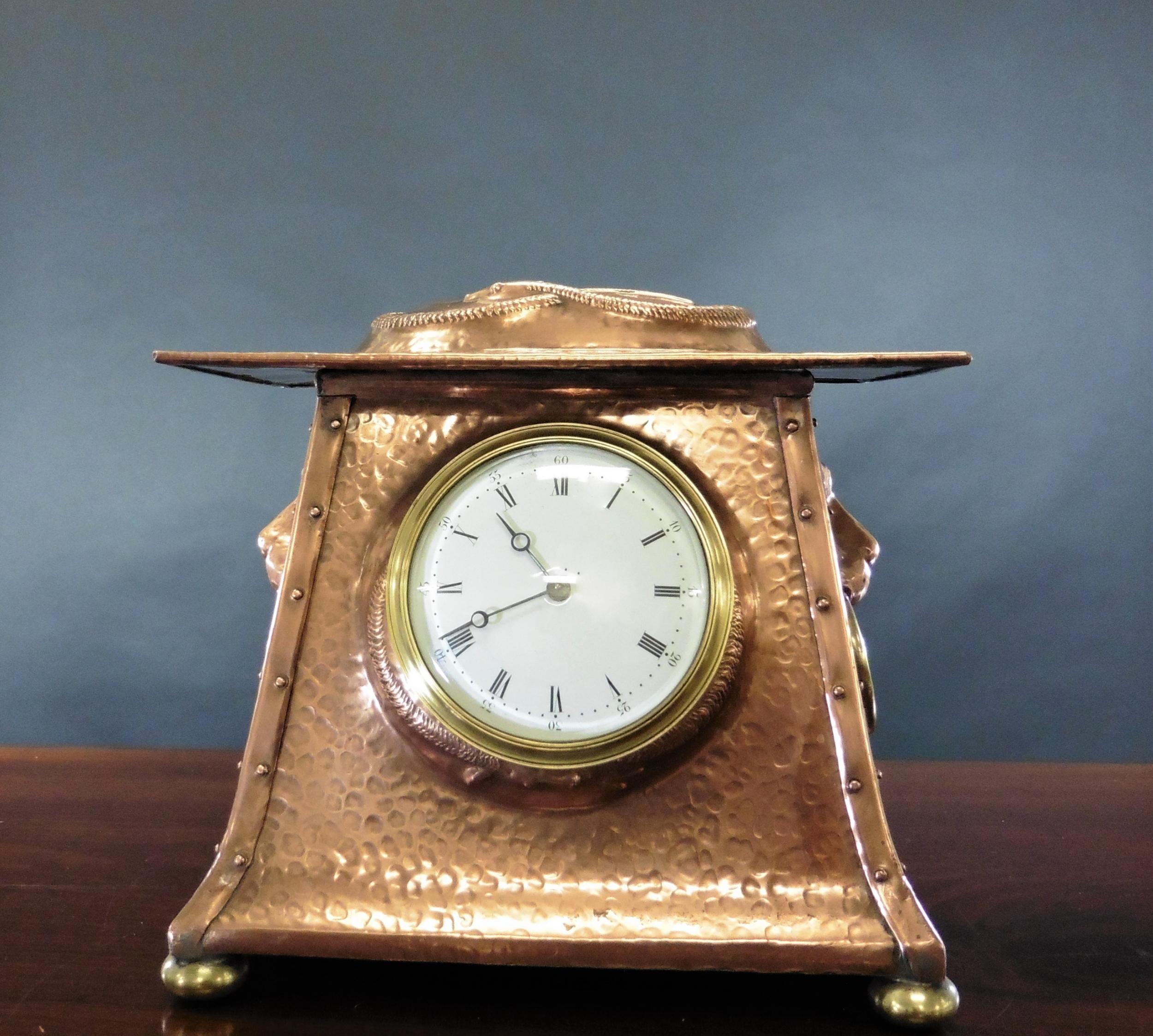 Arts and Crafts copper mantel clock


A most unusual Arts and Crafts mantel clock in an outswept hammered copper case with lions head ring side carrying handles and surmounted by a coiled serpent, resting on four brass bun feet.


Enamel dial