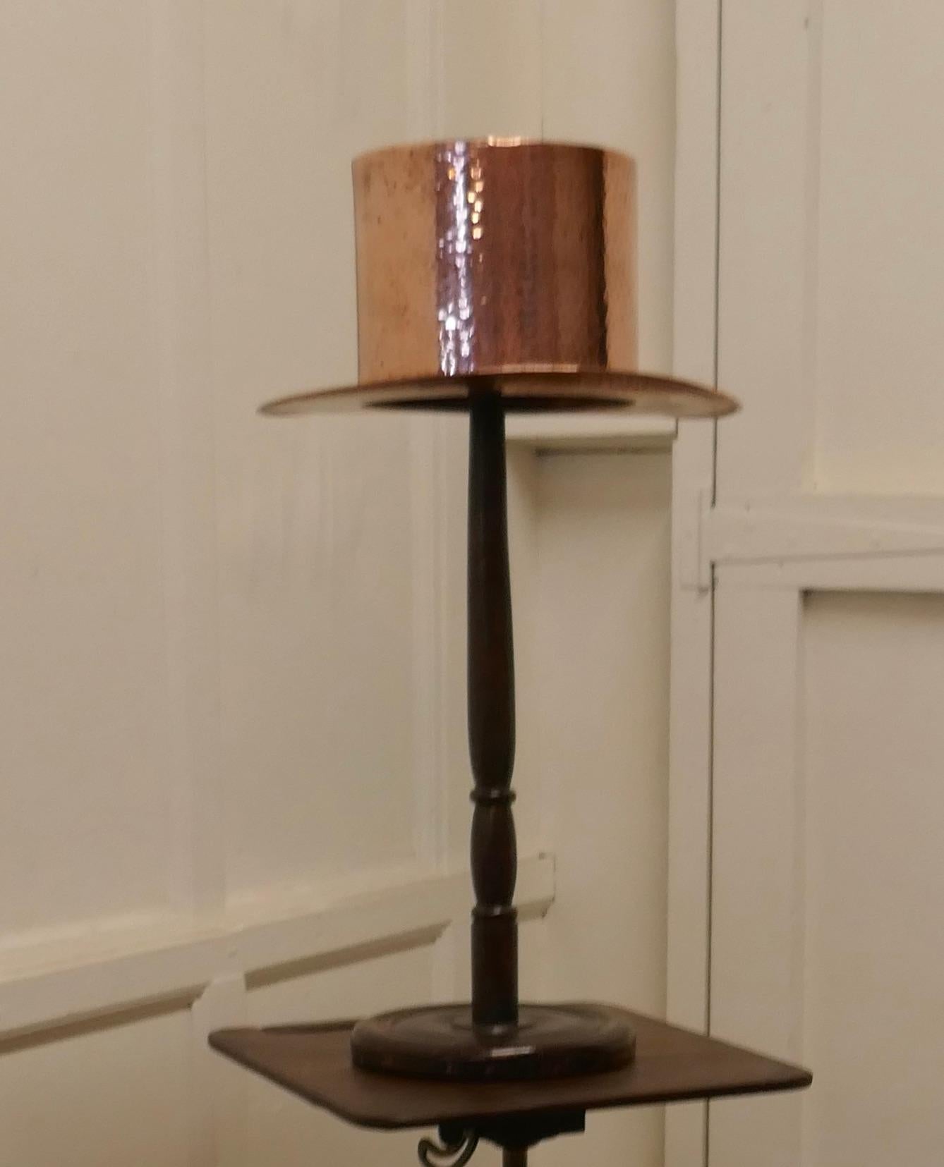 Arts and Crafts Copper Milliners Trade Sign. Copper Top Hat

This is an unusual piece, the Top Hat is made in beaten Copper it sits on an old wooden stand
The hat and stand are both in good all round condition
The hat on the stand is 26” high,