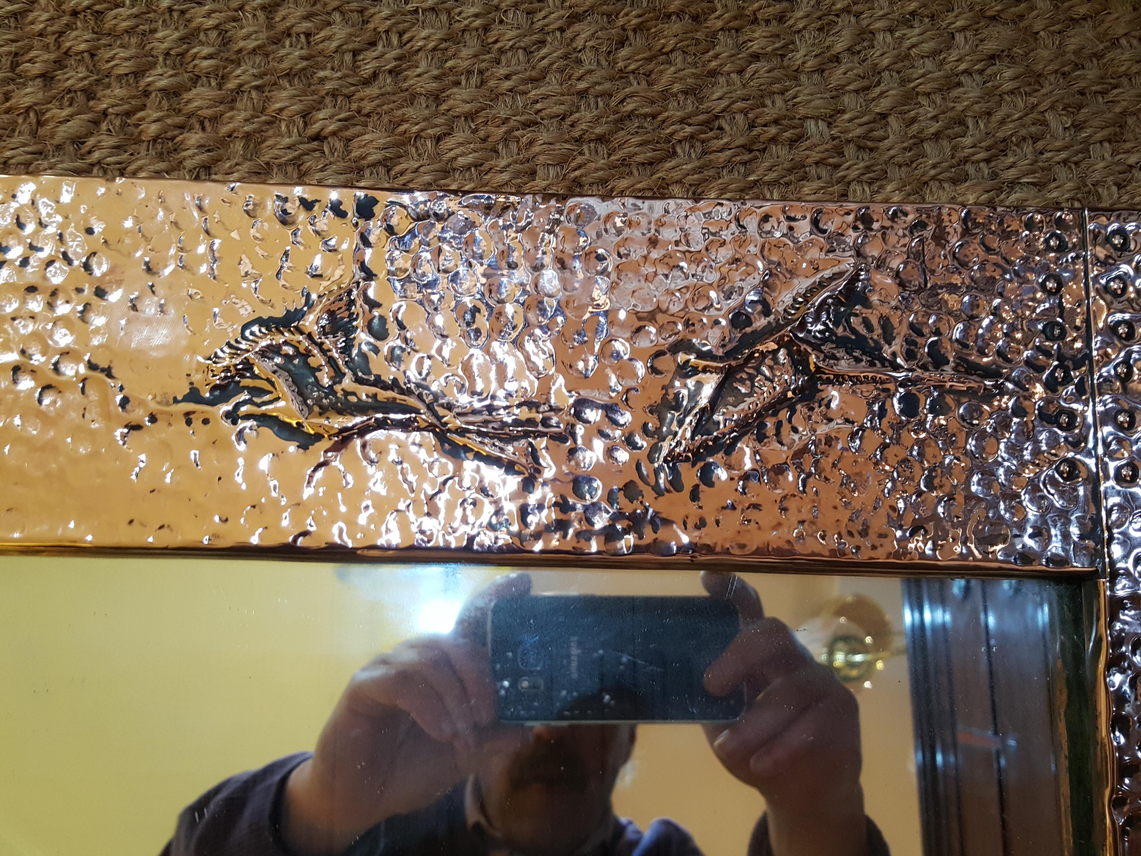 Arts & Crafts beaten copper mirror with embossed hunting scenes.
Measures: 20