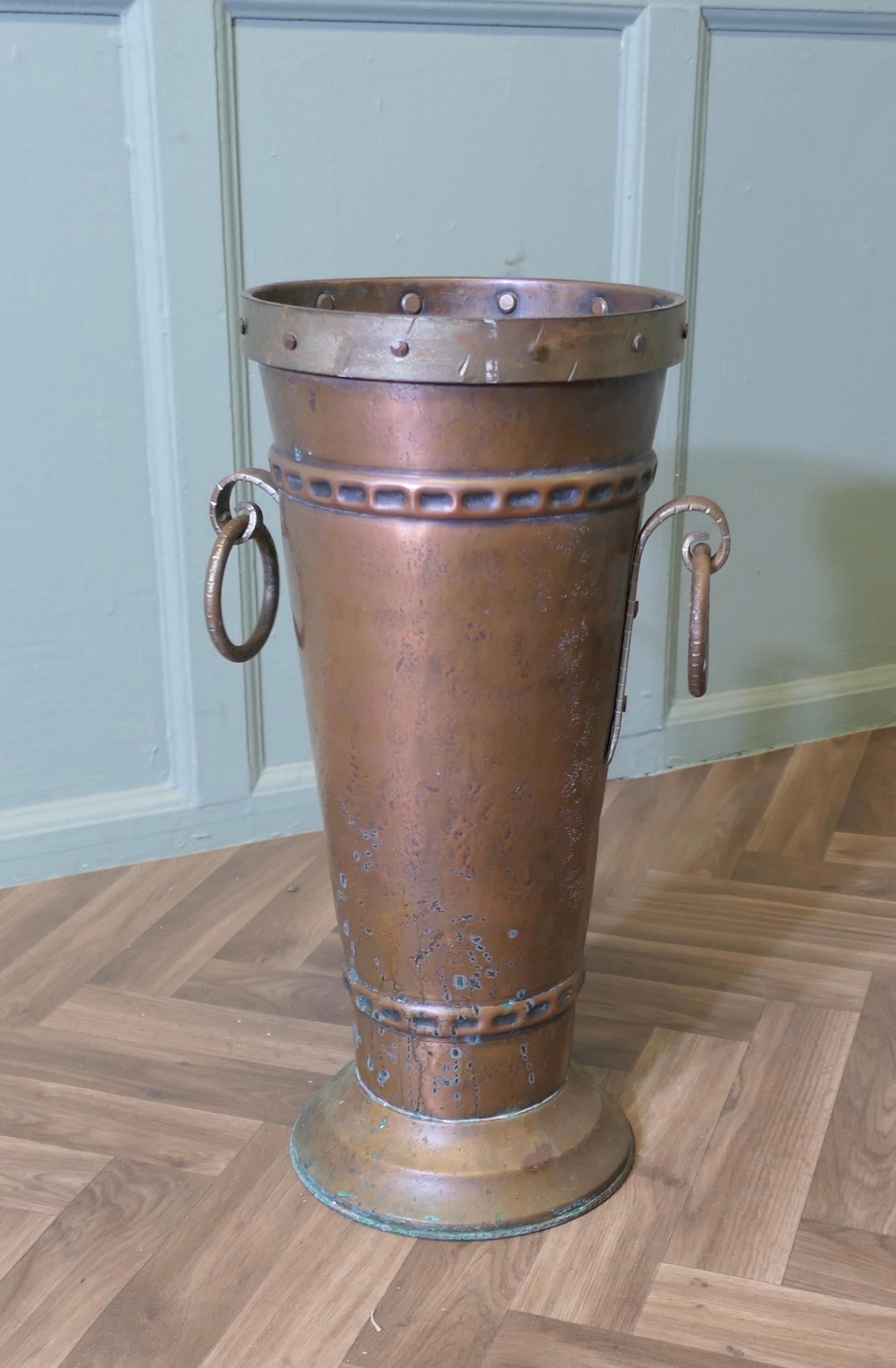 Arts and Crafts Copper Stick Stand, Umbrella Stand

A good quality and very stylish piece, the stand is cone shaped, it is made in hand beaten copper with a heavy.  ring handle on each side
The stand is in good condition and stable when full
It is