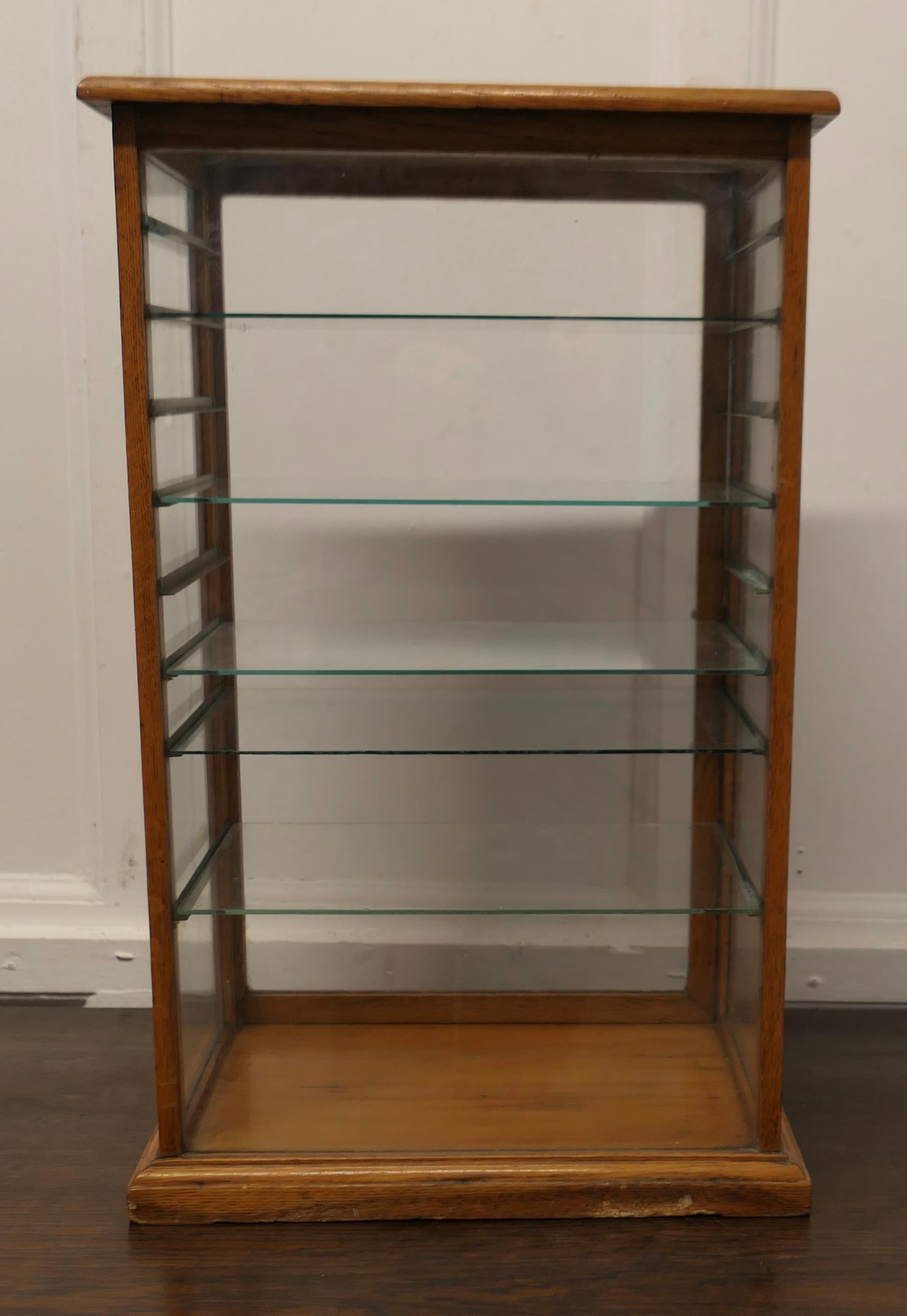 Arts and Crafts Counter Top Shop Display Cabinet, Watches, Jewellery


This is a Golden Oak fully glazed Shop Display Cabinet it has a glass door at the back and 5 adjustable glass shelves to the interior, the door has a working latch at the
