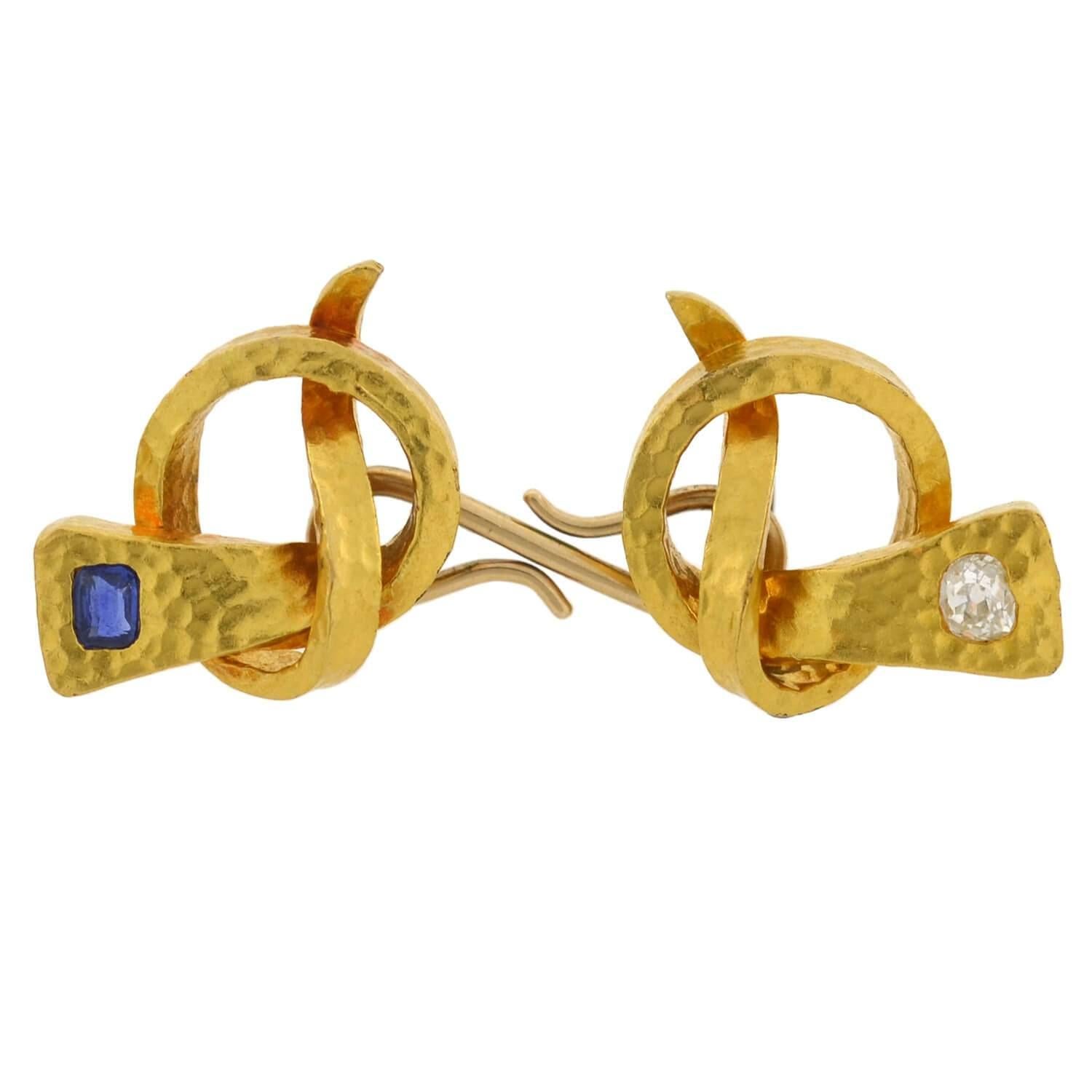A beautiful and unusual pair of gemstone cufflinks from the Arts and Crafts (ca1910) era! Crafted in vibrant 14kt yellow gold, these double-sided cufflinks are bursting with detail. Each is comprised of two horseshoe nails which are uniquely knotted