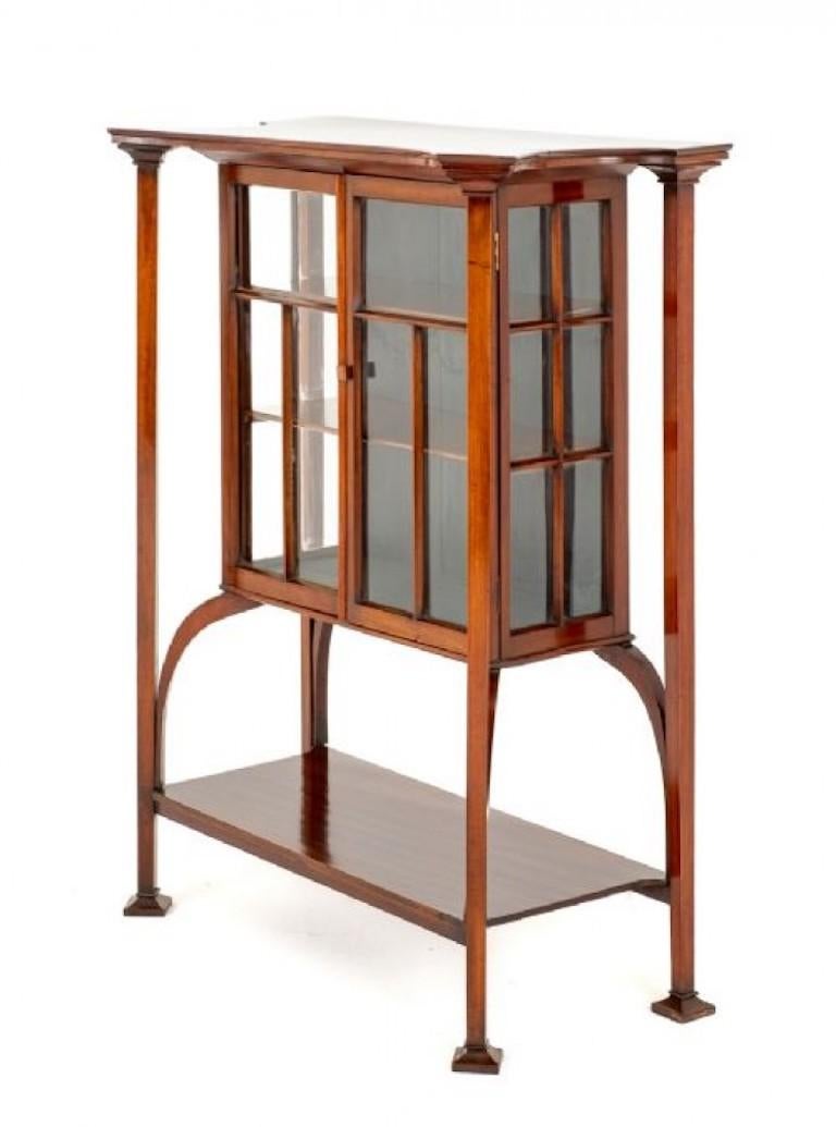 This Rather Unusual Display Cabinet is of a Typical Arts and Crafts Form.
Circa 1890
Featuring Square Uprights, Block Feet and Shaped Supports.
The 2 Glazed Doors Open to Reveal Shelving.
The Top of the Cabinet being of a Shaped Form.