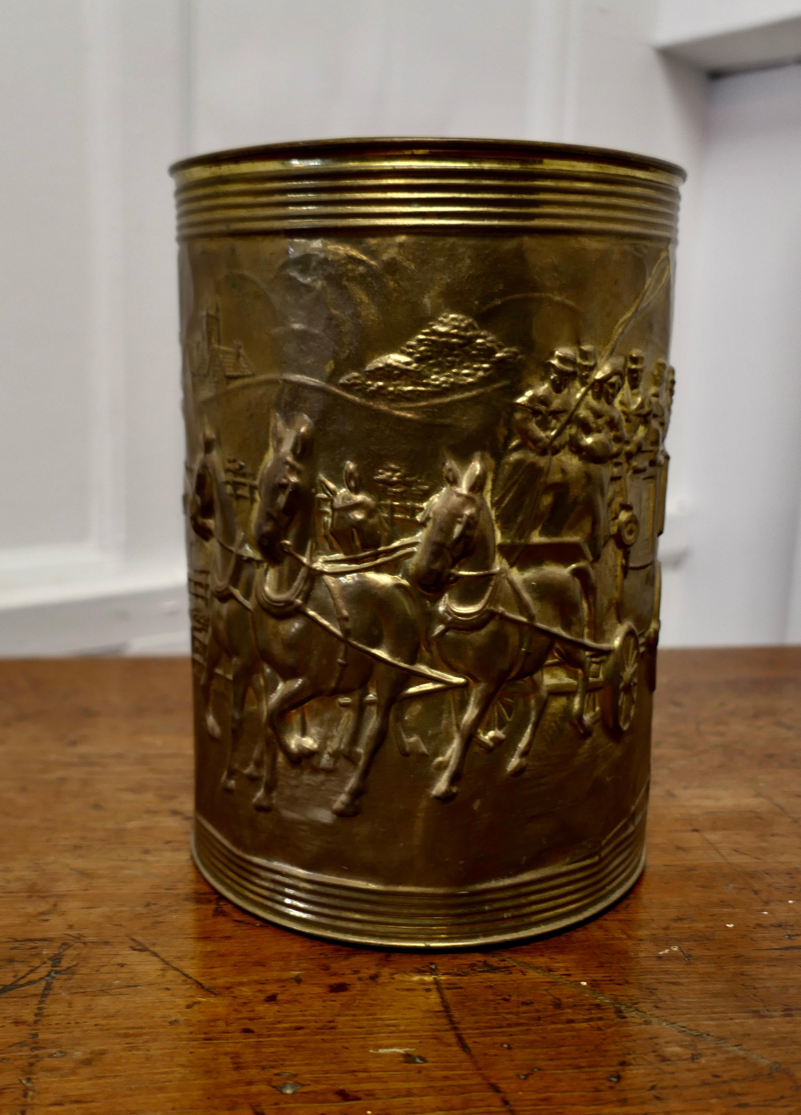 Arts and Crafts Embossed Brass Waste Paper Basket
 
This good looking piece it is round in shape with a Christmas Coaching scene embossed on the front. 
The bucket is in excellent condition, it is 10” high and 8” in diameter 
MS179.