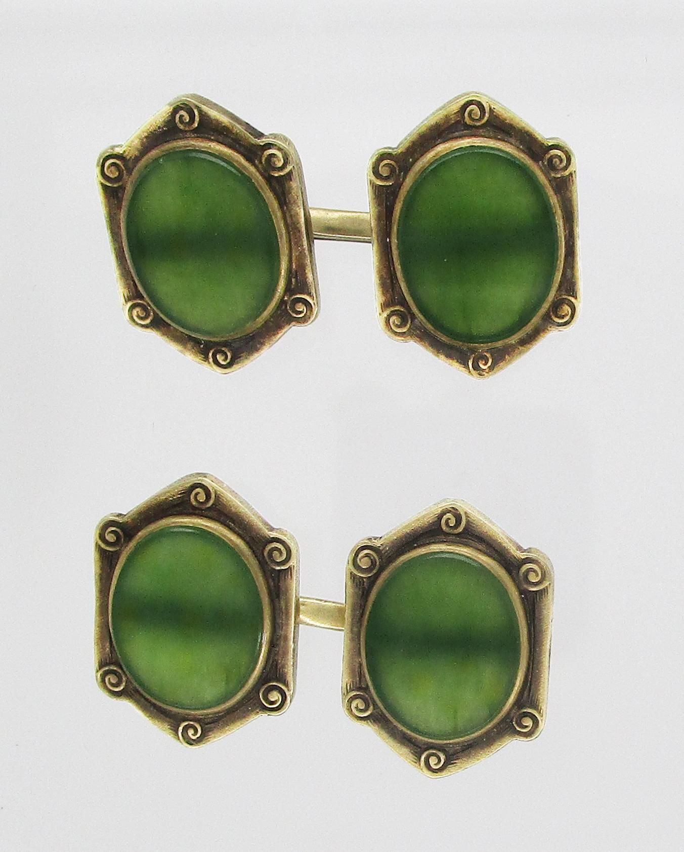In a magnificent example of the Arts and Crafts design, these cufflinks pair stunning green jade with 14k green gold frames to create the perfect accessory for the distinguished gentleman. The links boast translucent jade panels with a rich green