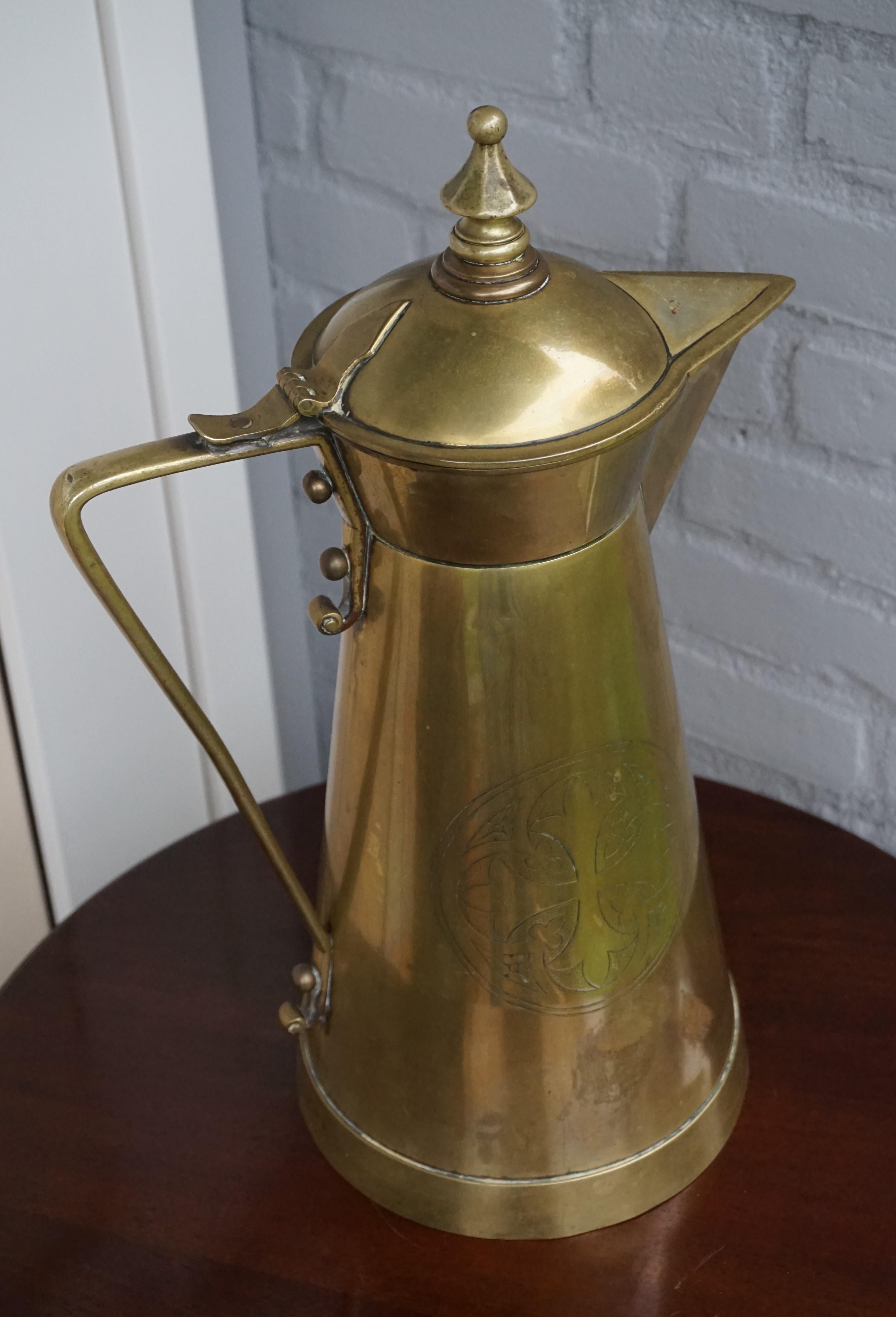 Sizable and unique Gothic church relic with the IHS Christogram and the Patonce cross.

This one of a kind, heavy brass antique is another one of our recent great finds. The design of this jug clearly shows that it was handcrafted in the Arts and