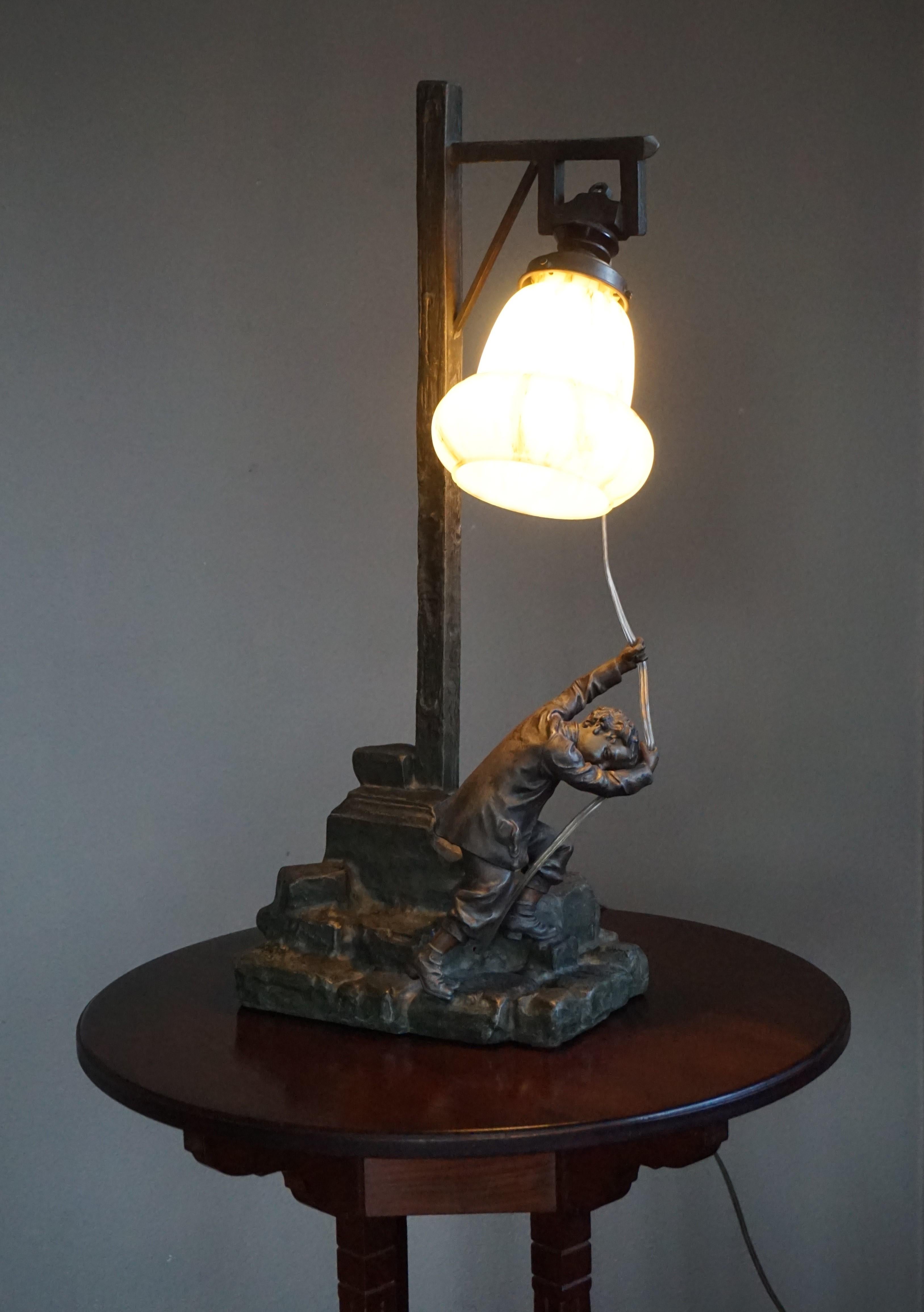 Large and highly decorative antique table lamp with stunning quality boy sculpture.

If you are looking for a rare and meaningful table lamp that is also great to look at, then this could be the one for you. At the center of this early 20th century