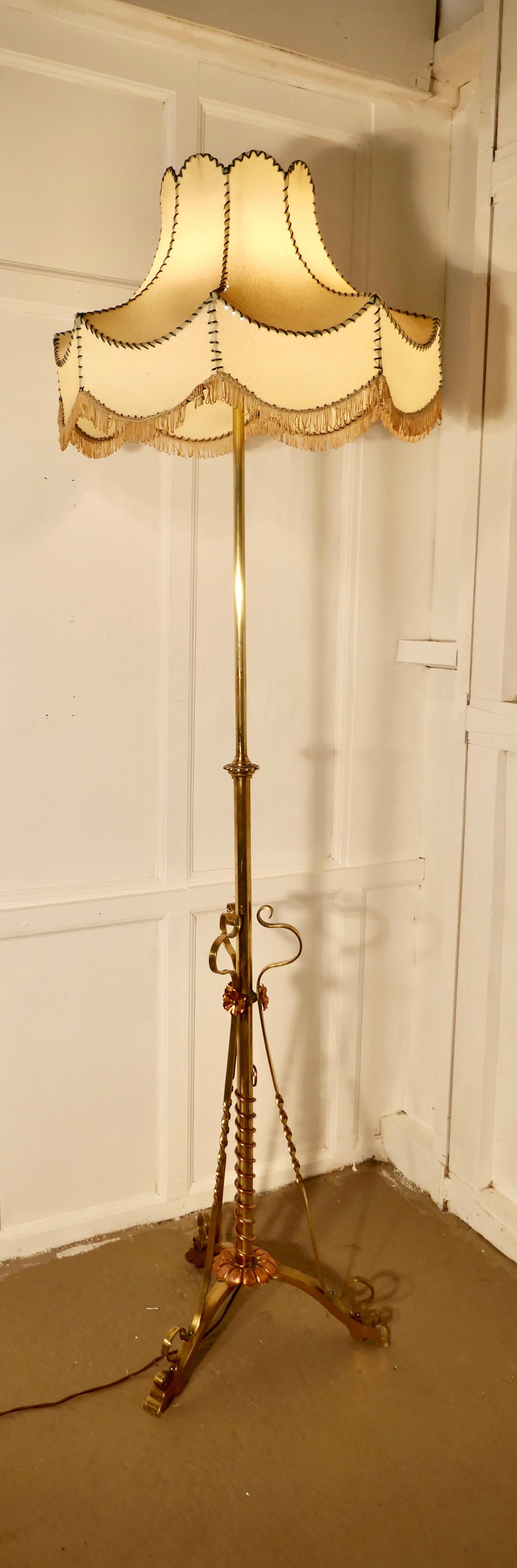 Arts & Crafts extending brass floor lamp, standard lamp

This is a very attractive piece, the lamp has a long telescopic action and a decorative brass base with a twisted copper decoration
I have shown the lamp with a shade, this is not included,