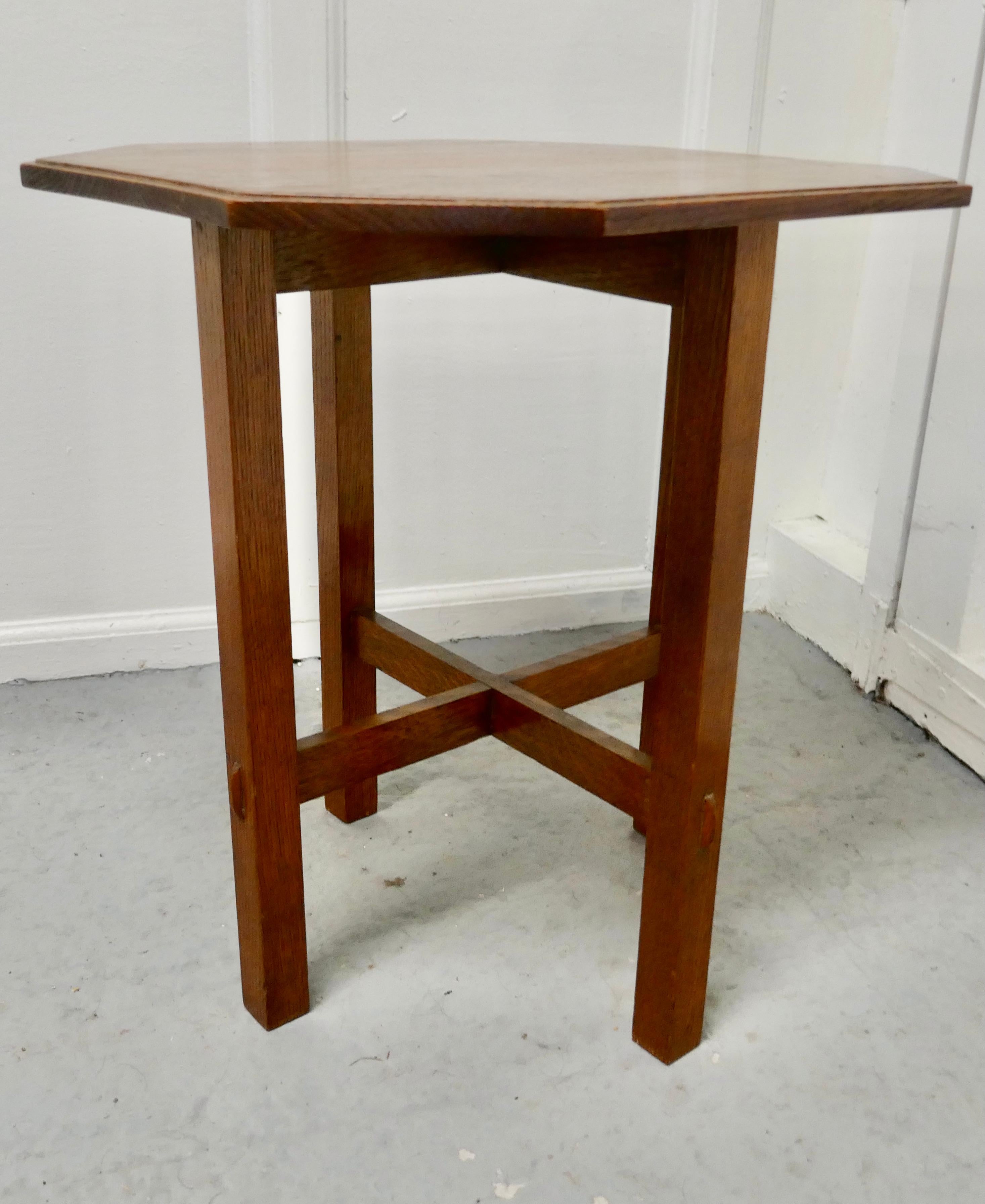 Arts & Crafts golden oak octagonal occasional table

This is a pretty and useful piece, the table is almost square with chamfered corners, it stands on square legs with pegged stretchers
The table is in good condition it is 21” high, and 19” wide