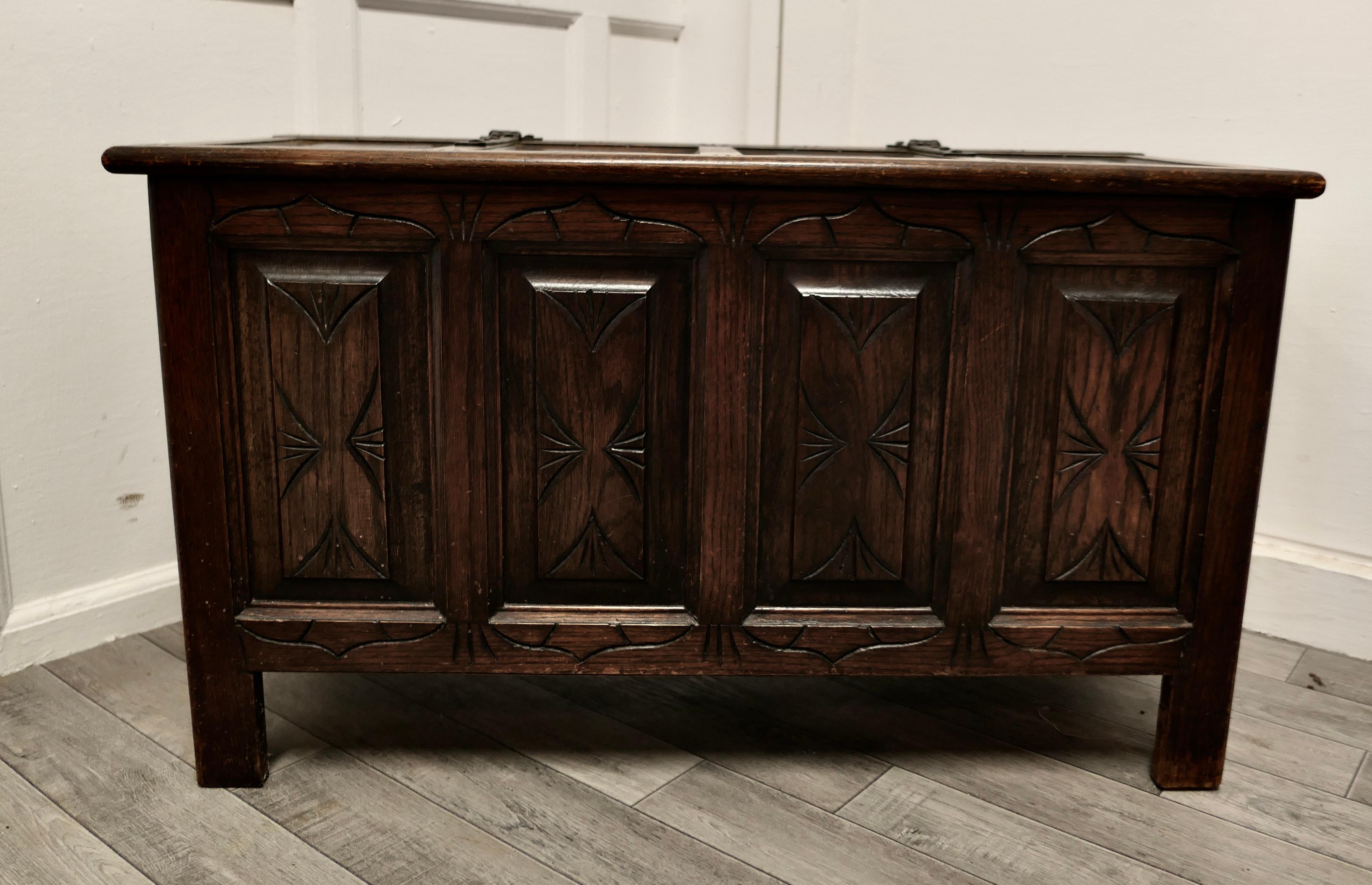 Arts and Crafts Gothic carved panelled oak coffer. 

This is a lovely piece, with a good patina, the chest has four carved panels on both the front and top.
The sides the chest have moulded panels and the chest has blacksmith made hinges.
The