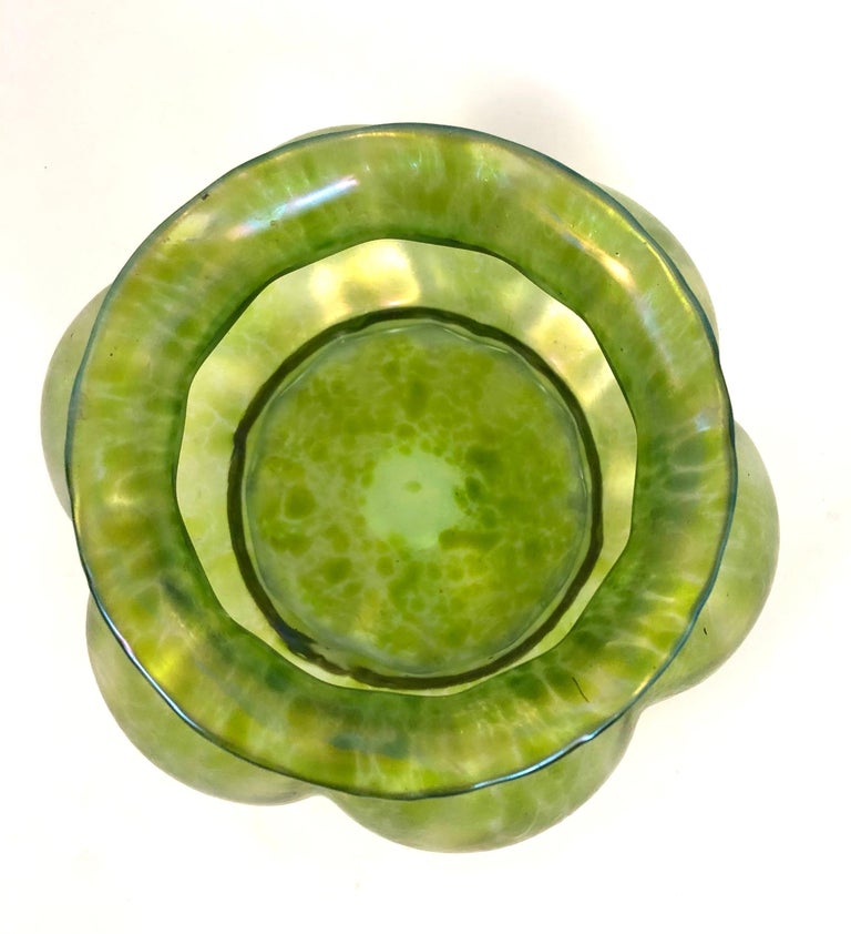 A fine quality Arts & Crafts period green blown glass flower vase, in the manner of Tiffany, of lobed circular form with mottled surface, with a polished pontil base.