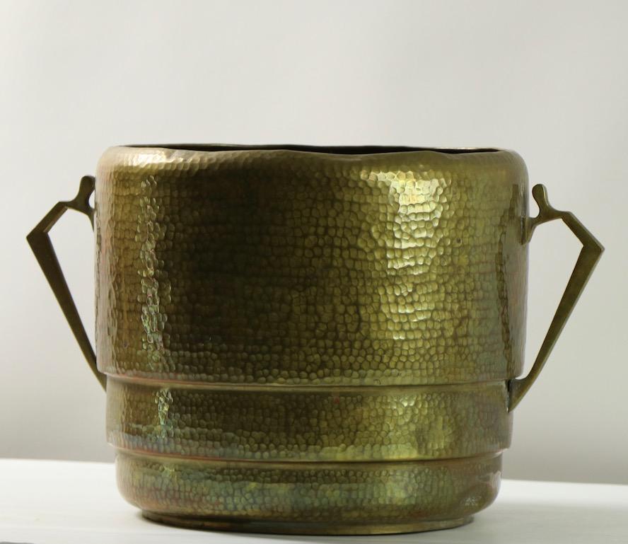 Nice hand hammered brass bucket, probably for kindling wood, also suitable for use as a planter etc. European Arts & Crafts, marked fire bronze on the bottom. The bucket has two handles, total width including handles 16 inch x diameter without