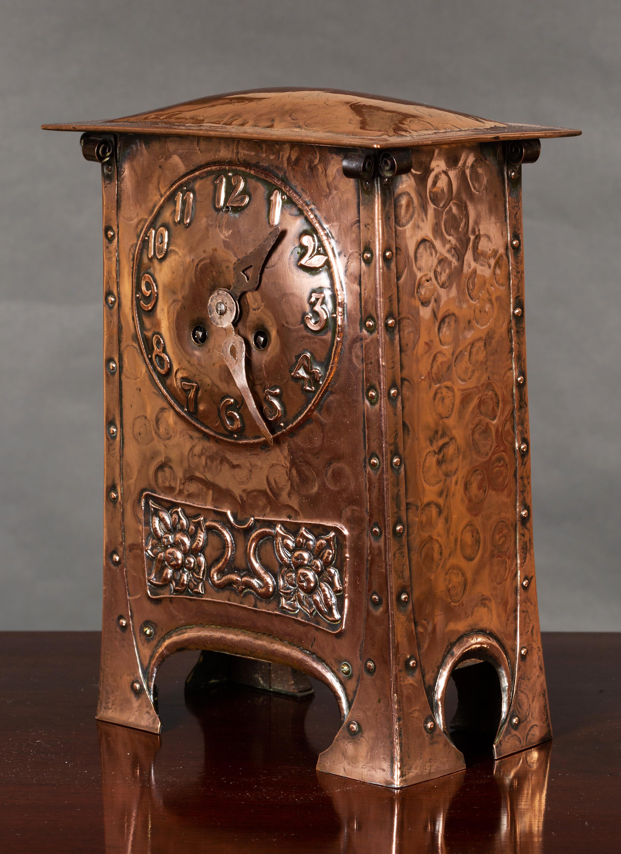 Arts & Crafts mantel clock in a dome top hammered copper case with raised frieze and beaded decoration. 

Aesthetic style numerals and copper hands. 

Eight day French movement striking the hours and halves on a coiled gong, numbered 465., circa