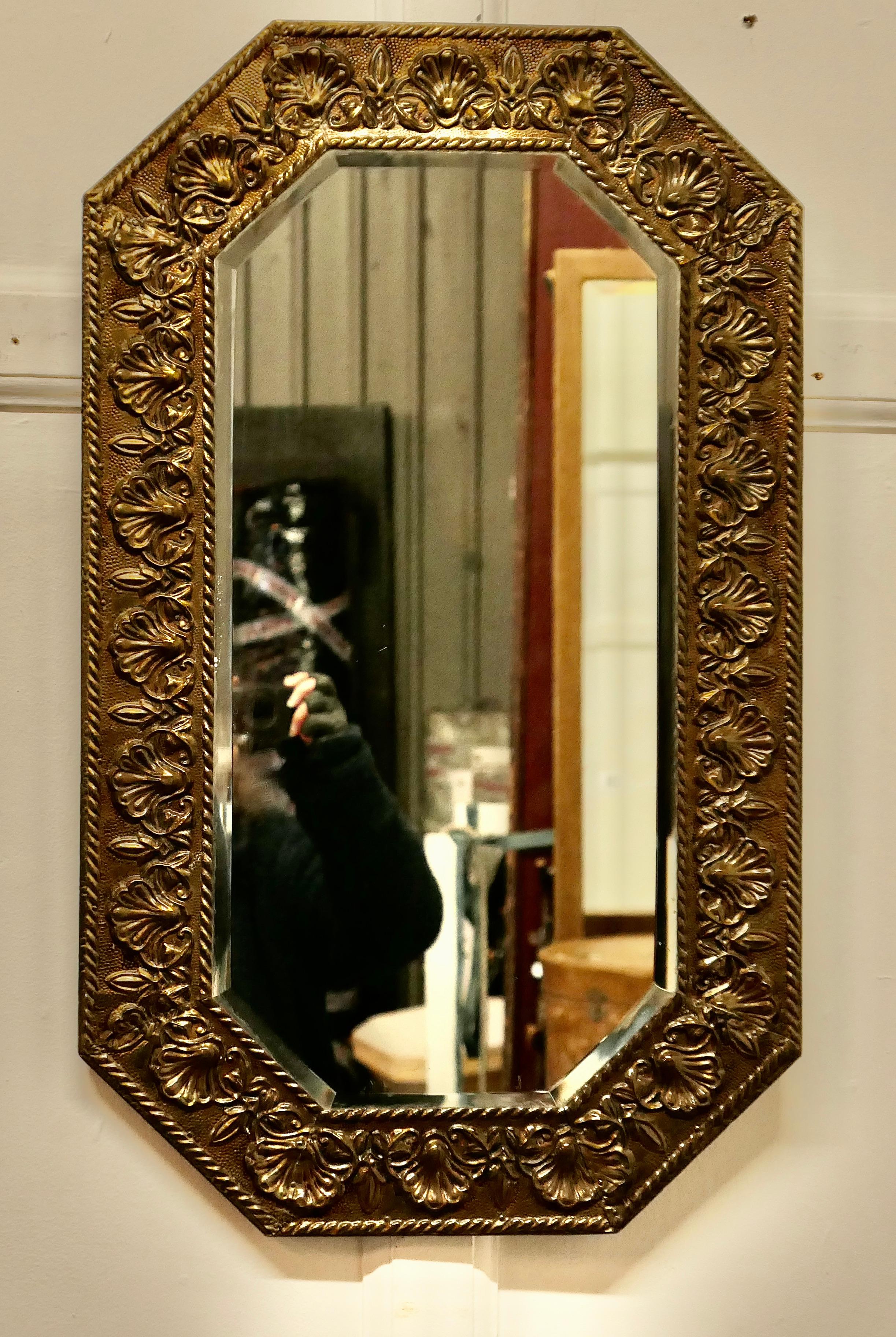 Arts and Crafts Hand Beaten Brass Mirror 


This is a classic mirror of this era, at the centre an Octagonal bevelled mirror and this is set in a 3.5” wide hand beaten brass frame, the mirror has a shell and rope decoration 
This is a good quality