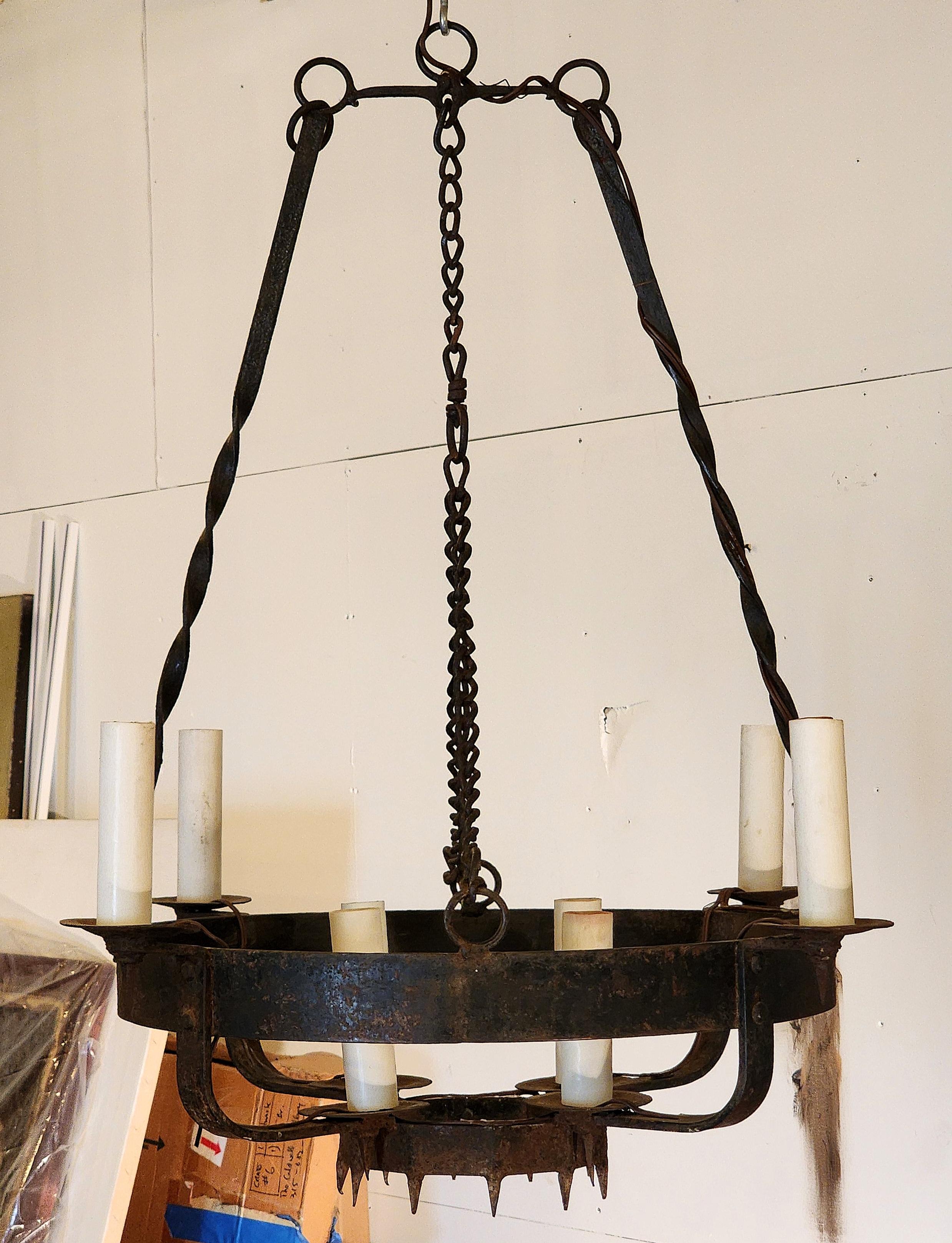 Well proportioned and beautifully made hand wrought iron Chandelier in the Arts and Crafts Style with many details. Has been electrified to hold eight chandelier size bulbs. This item can add character to any interior space or exterior. The