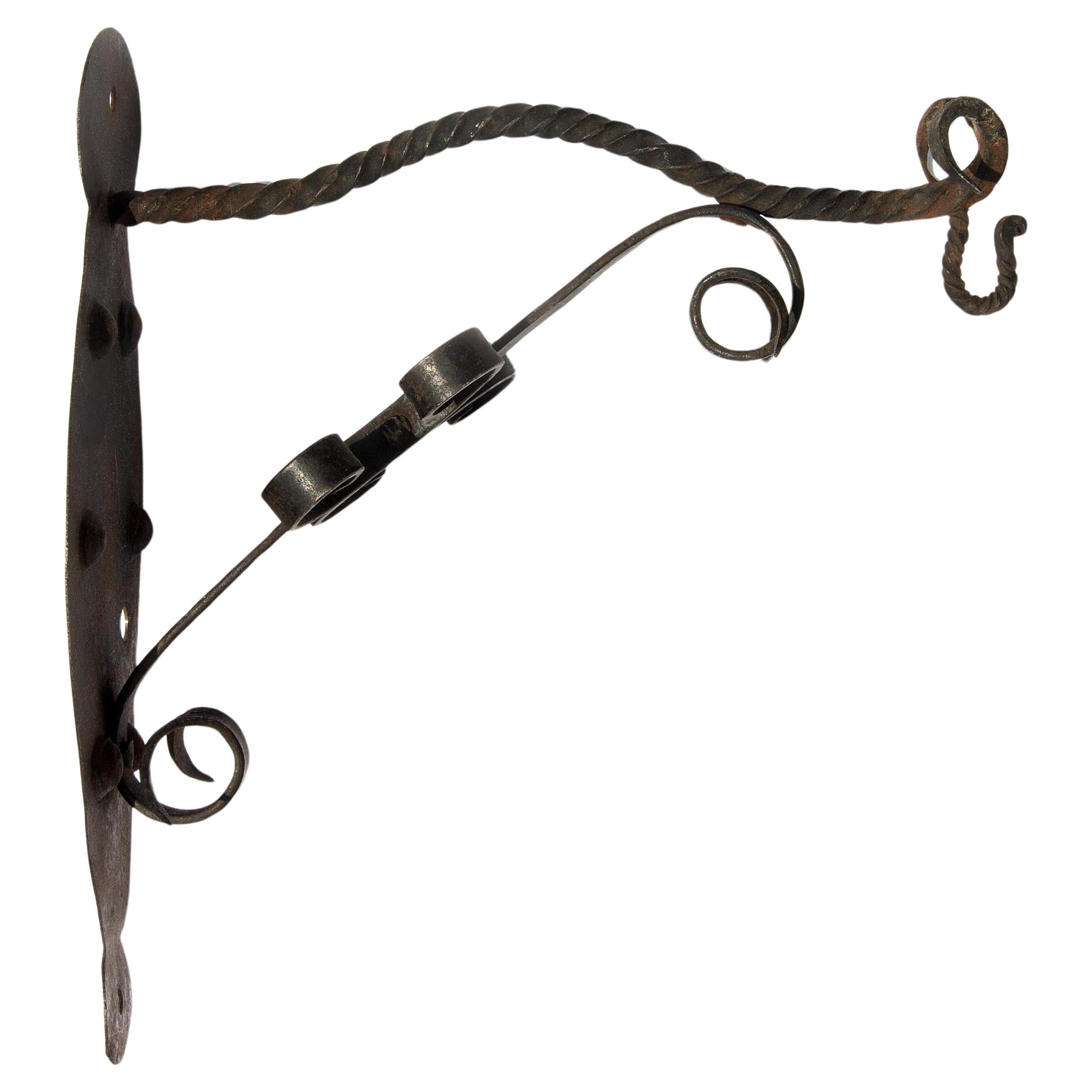Hand wrought iron arts and crafts light or plant wall bracket. Circa 1910.
