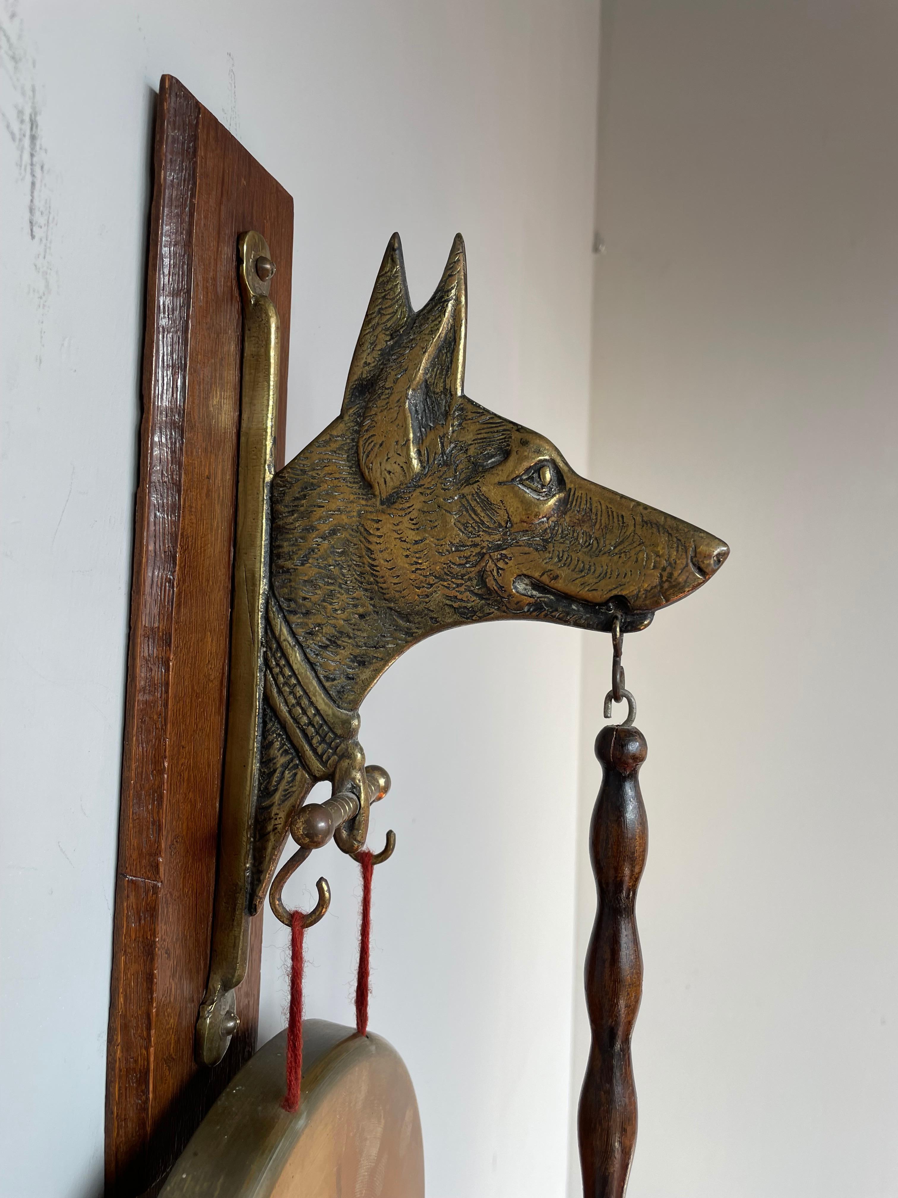 Very rare and striking (pun intended) Arts & Crafts gong.

This remarkable house gong with a sheepdog sculpture even comes with the original and perfect working condition striker. The beautifully handcrafted dog and gong are a real joy to look at