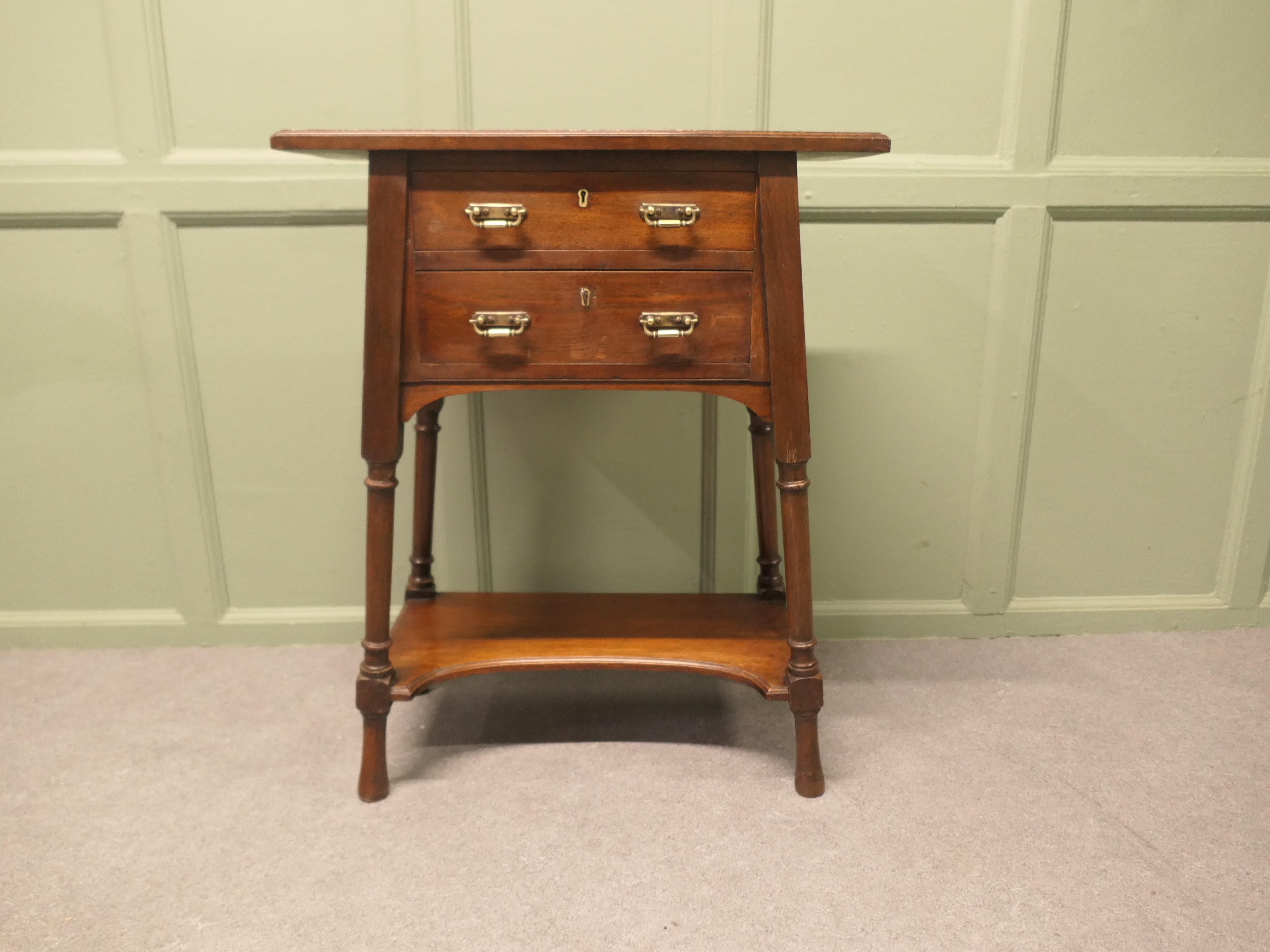 Arts and Crafts Jeweller’s Side Table  

The table has a rectangular top, stylish splayed legs and a crinoline shaped under tier. 
This is a very superior quality piece, the table has been made for a jeweller, it has 2 lockable drawers, the locks