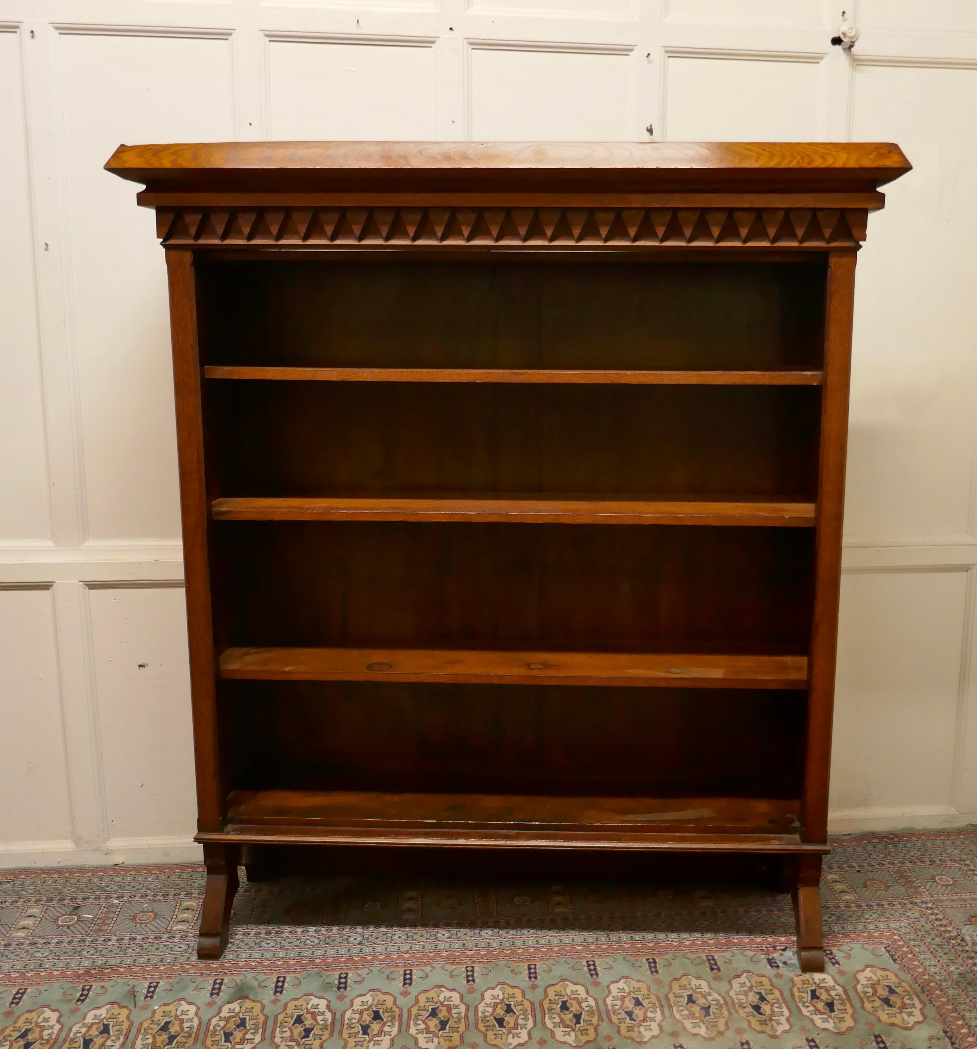 Arts & Crafts large golden oak open bookcase

This is an excellently designed piece, it is very much in the Arts & Crafts style, with a decorative cornice
The book case is made in oak, it holds 3 adjustable shelves these are veneered in oak along