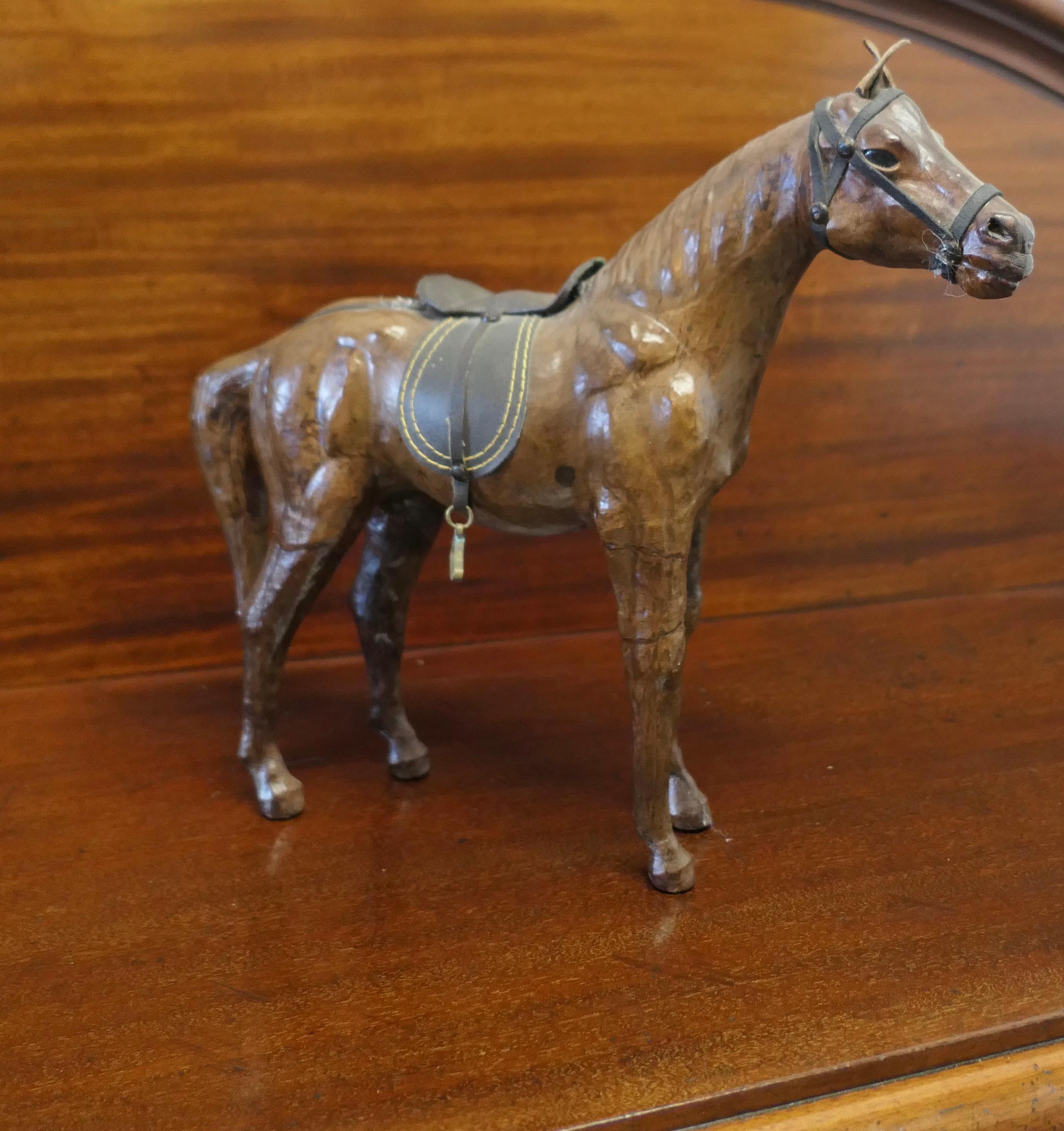 Arts and Crafts Leather Model of a Horse

This is a rare and beautiful find, it was probably made for Liberty but there is no label
This handsome beast is free standing, he has a saddle, bridle and a charming expression 
The condition is entirely