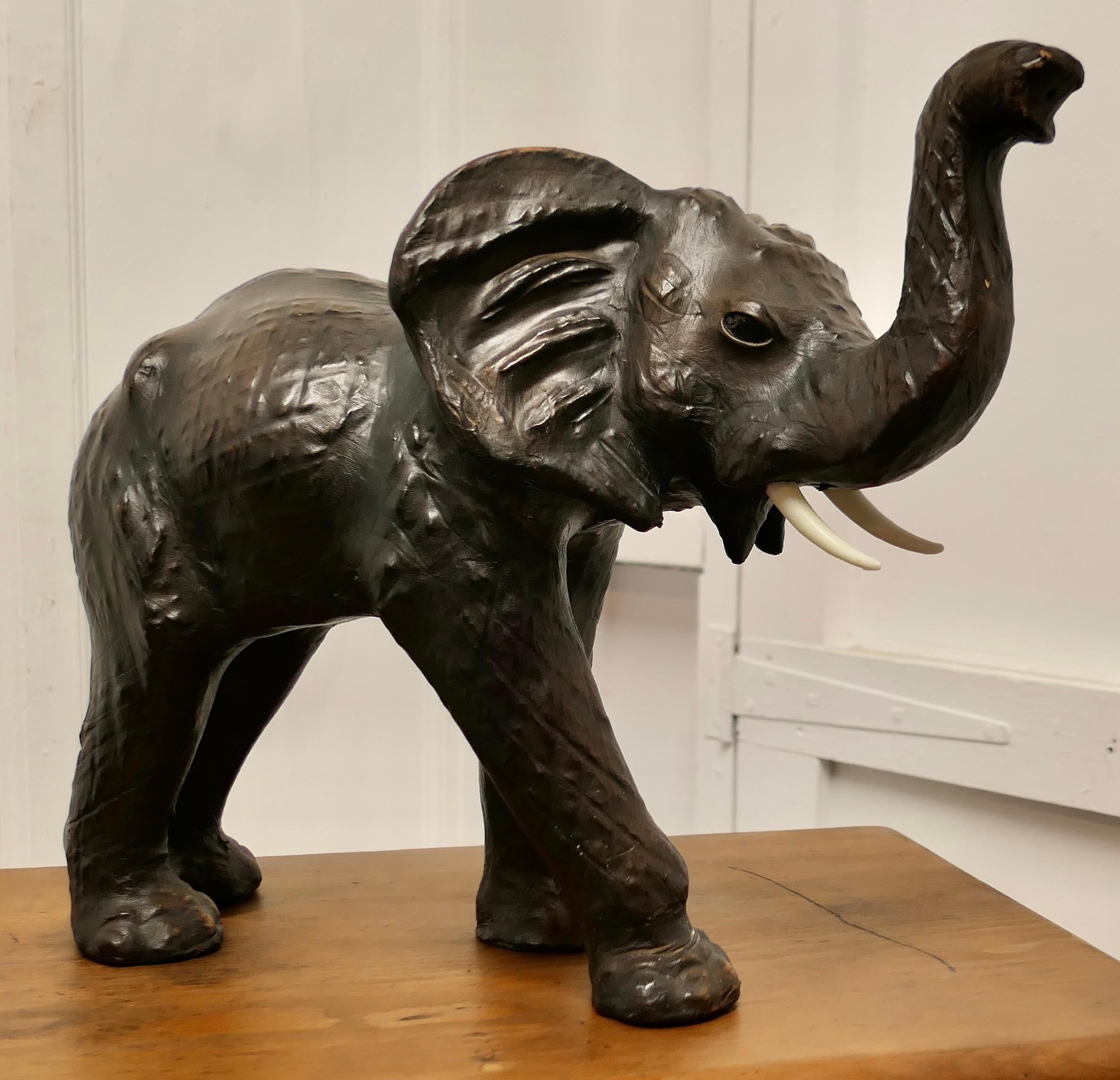 Arts and Crafts Leather Model of an Elephant 

This is a rare and beautiful find from the early part of the 20th Century, it was made for Liberty and is known as “Junior Bull”
This hansom beast is free standing, he is made in Leather, the tusks are