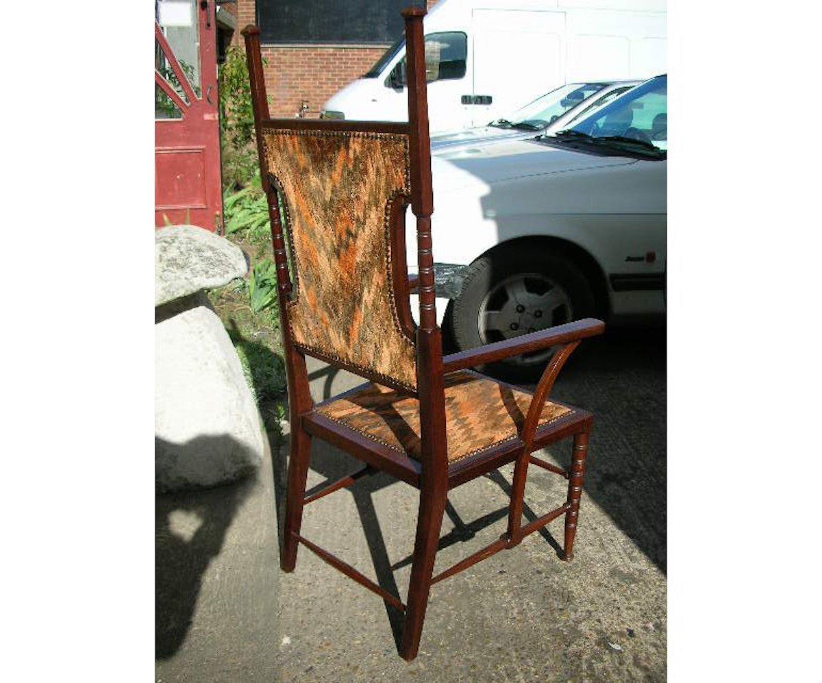 Liberty and Co Attributed. A late Aesthetic Movement Walnut Armchair. For Sale 1