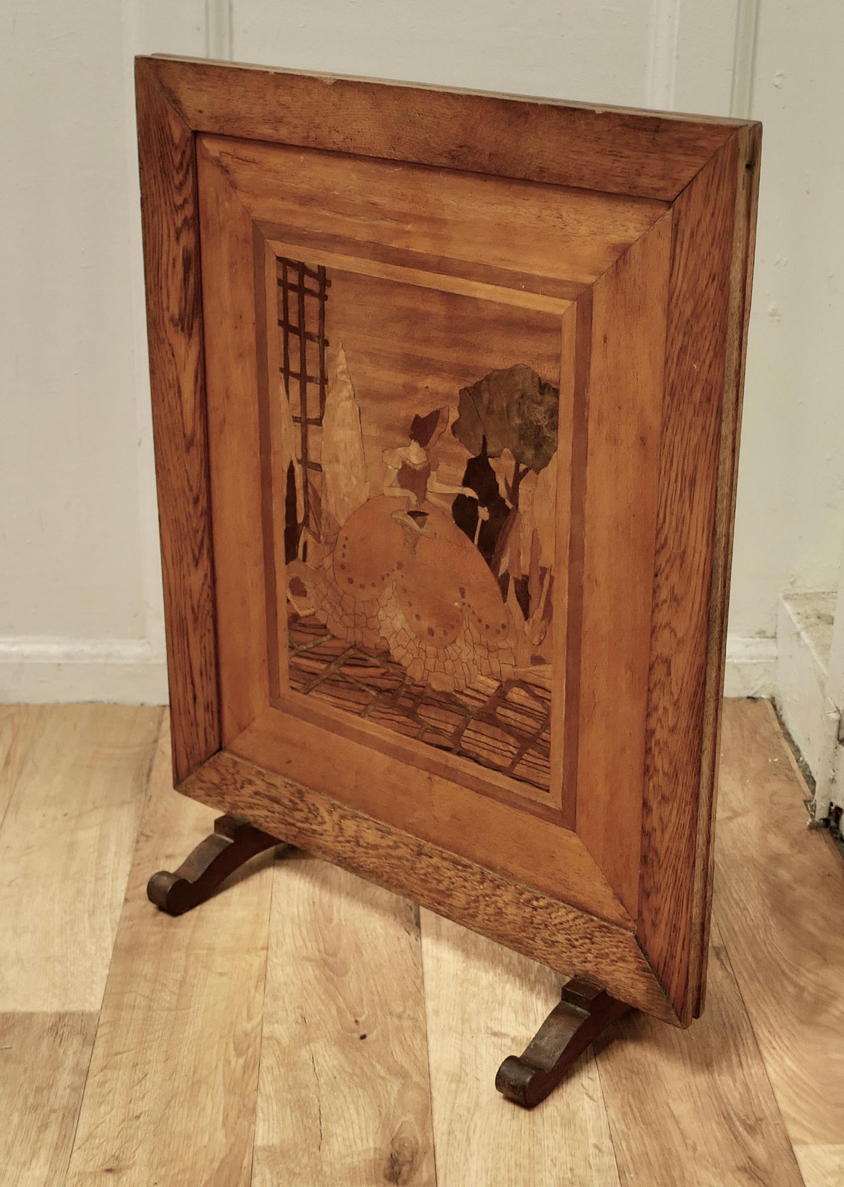 Arts and Crafts Marquetry Fire Screen 
 
This piece hails from the 1920s it is probably from the Rowley Gallery of Kensington, it made in an Oak frame and has an inlaid marquetry panel of a lady wearing a crinoline in a garden scene
The Screen is