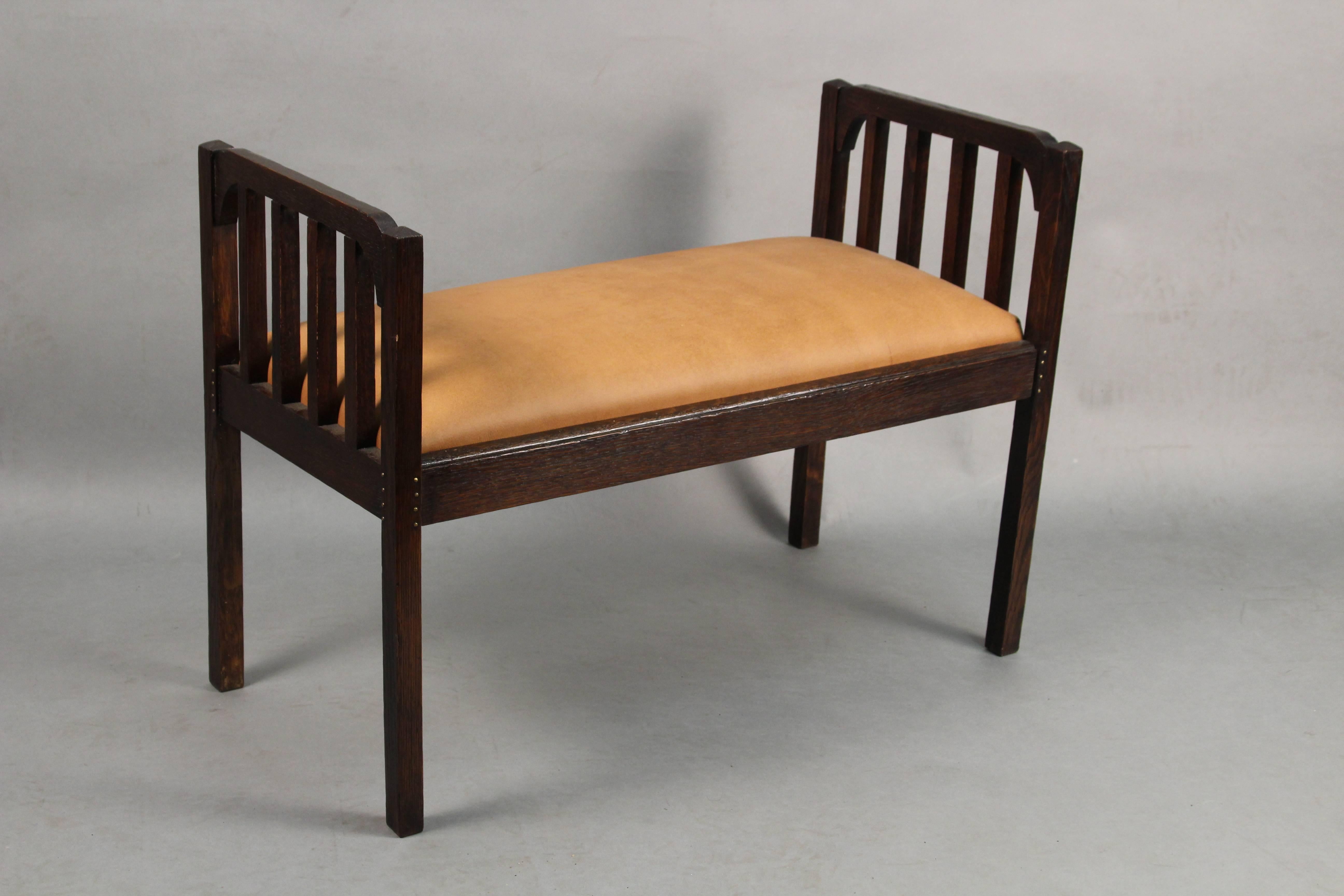 Bench with side slats, circa 1910. New leather upholstery. Measures: 21