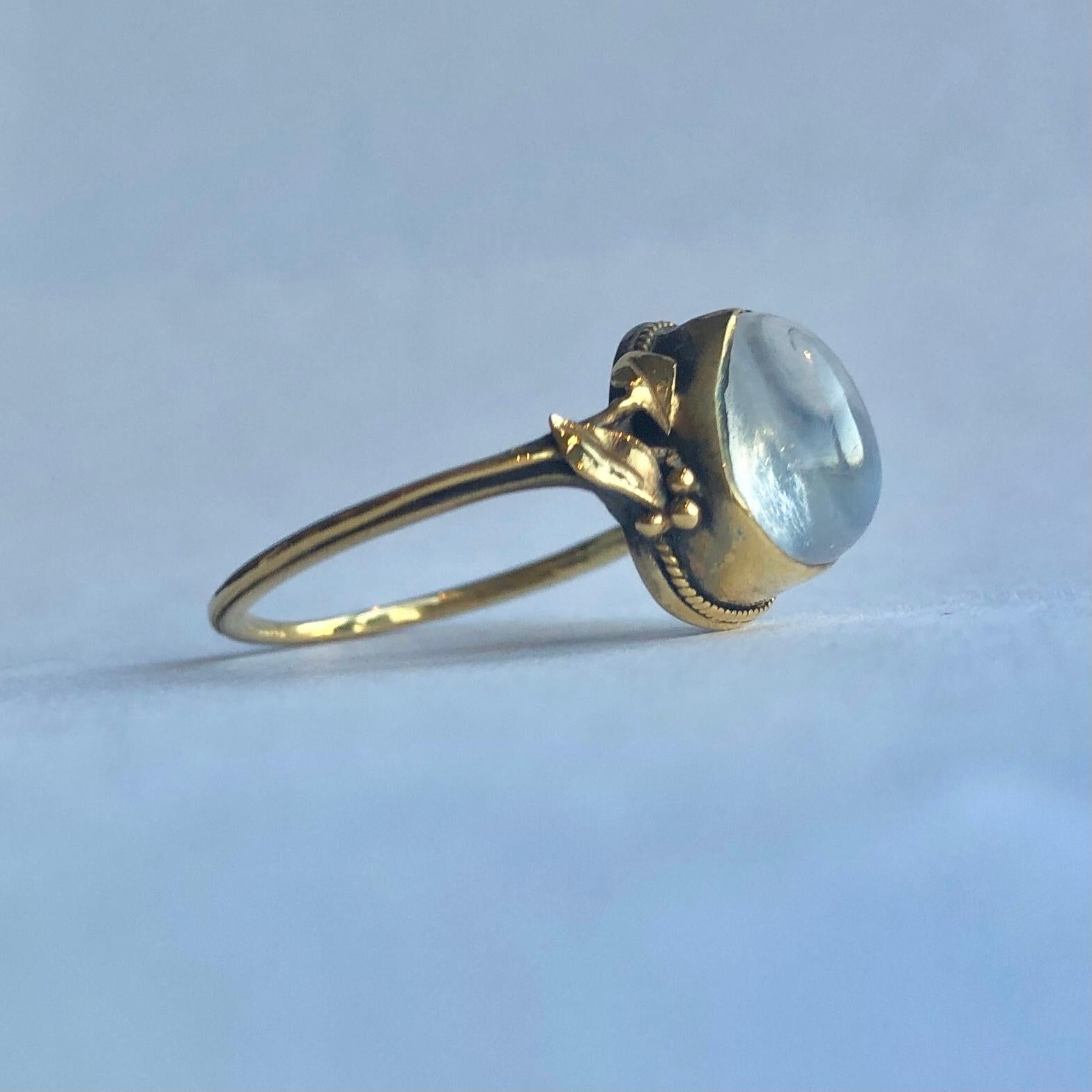 This wonderful glossy 9carat gold band was made in the arts and crafts movement and holds a gorgeous tear drop moonstone. The shoulders have details of berries and leaves which leads to a delicately thin band. 

Ring Size: N 1/2 or 7  
Height Off