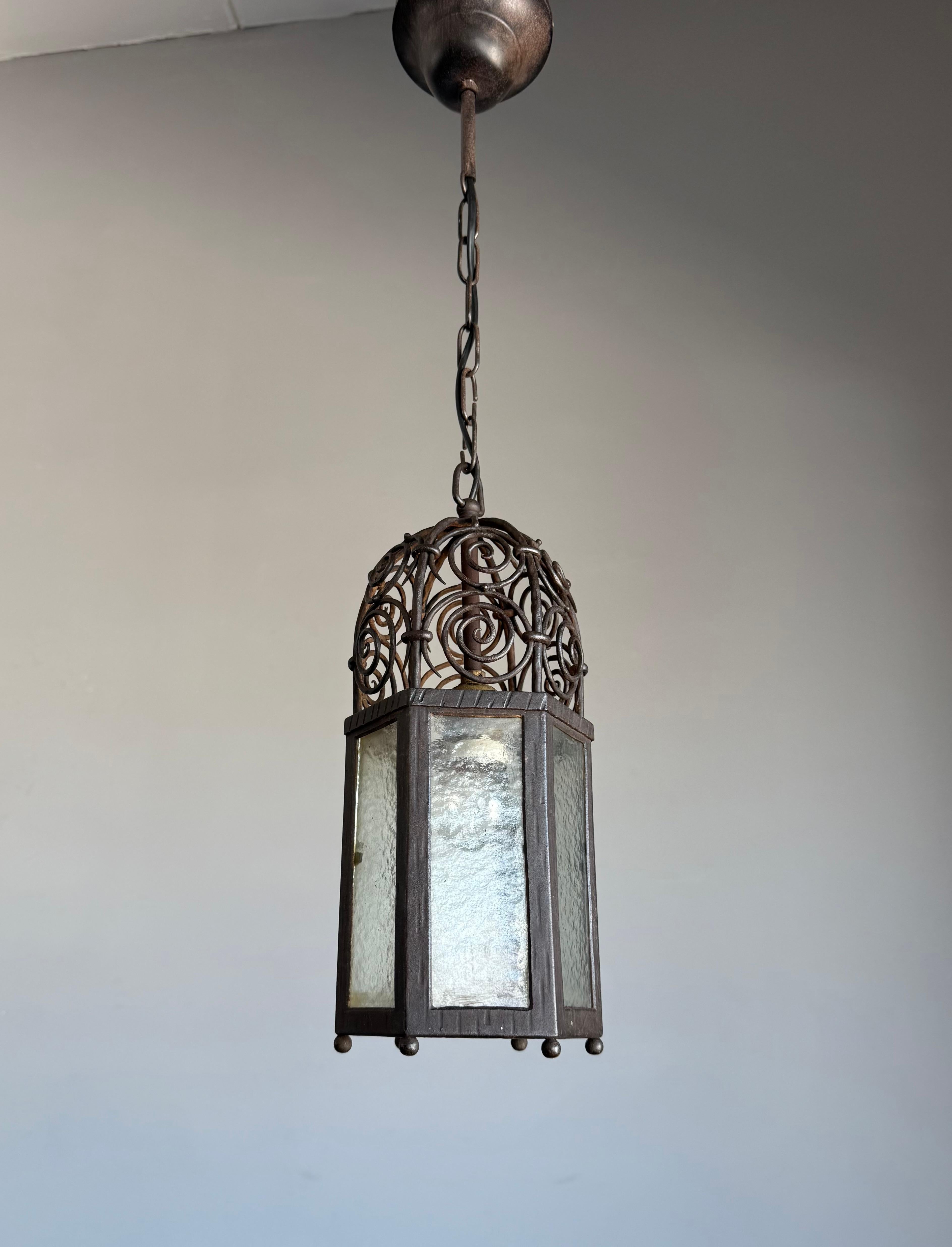 Rare and Finely Handcrafted Antique Wrought Iron Lantern Pendant with Cathedral Glass — Early 1900s

This beautifully handcrafted hallway lantern is a rare find, dating back to the earliest years of the 1900s. Finely forged from wrought iron and
