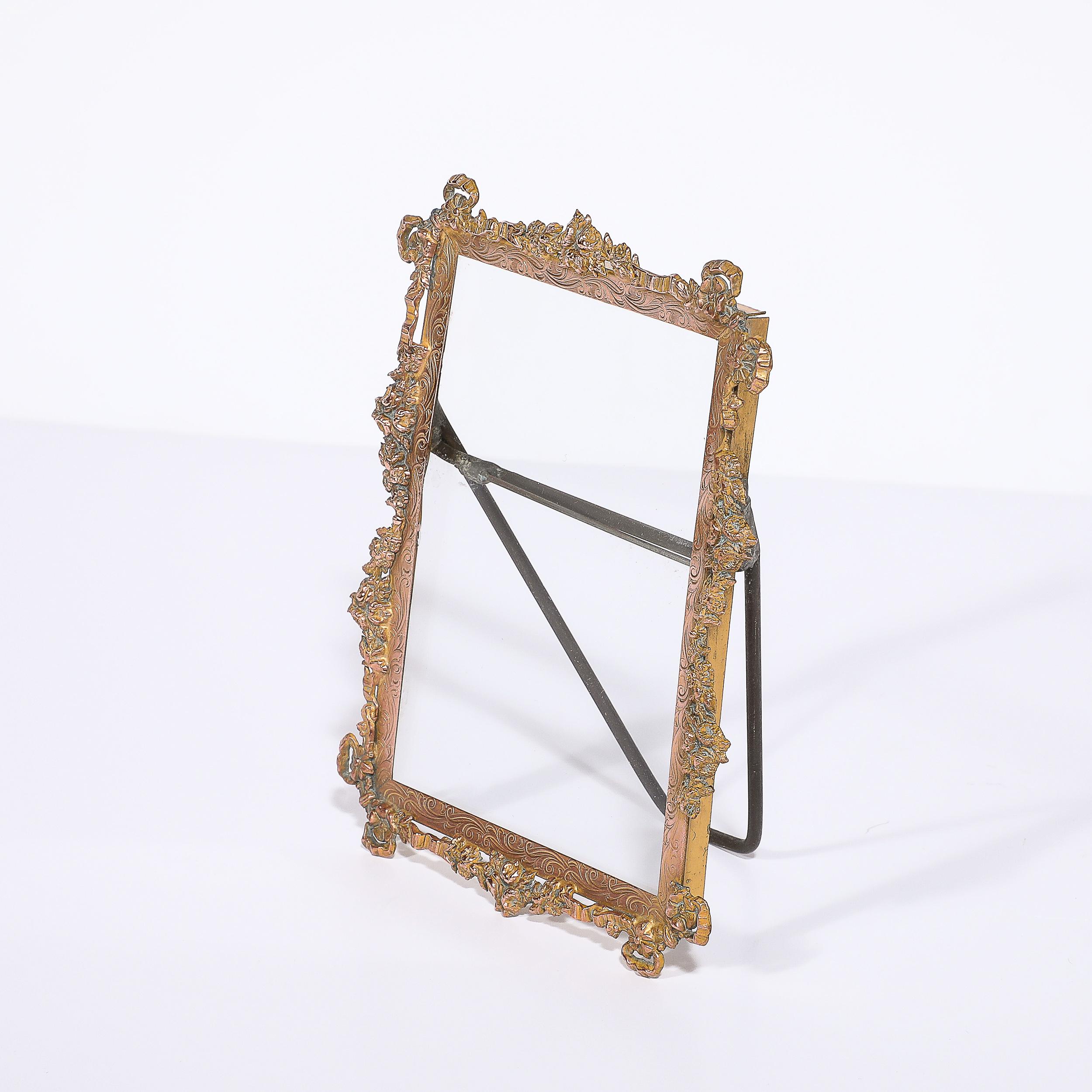 This exquisitely made Arts and Crafts Movement Brass Picture Frame with Ornate Naturalist Motif originates from France, Circa 1920.  Features an elegant curvaceous frame in brass, ornately decorated with foliate detailing, mirrored perfectly on