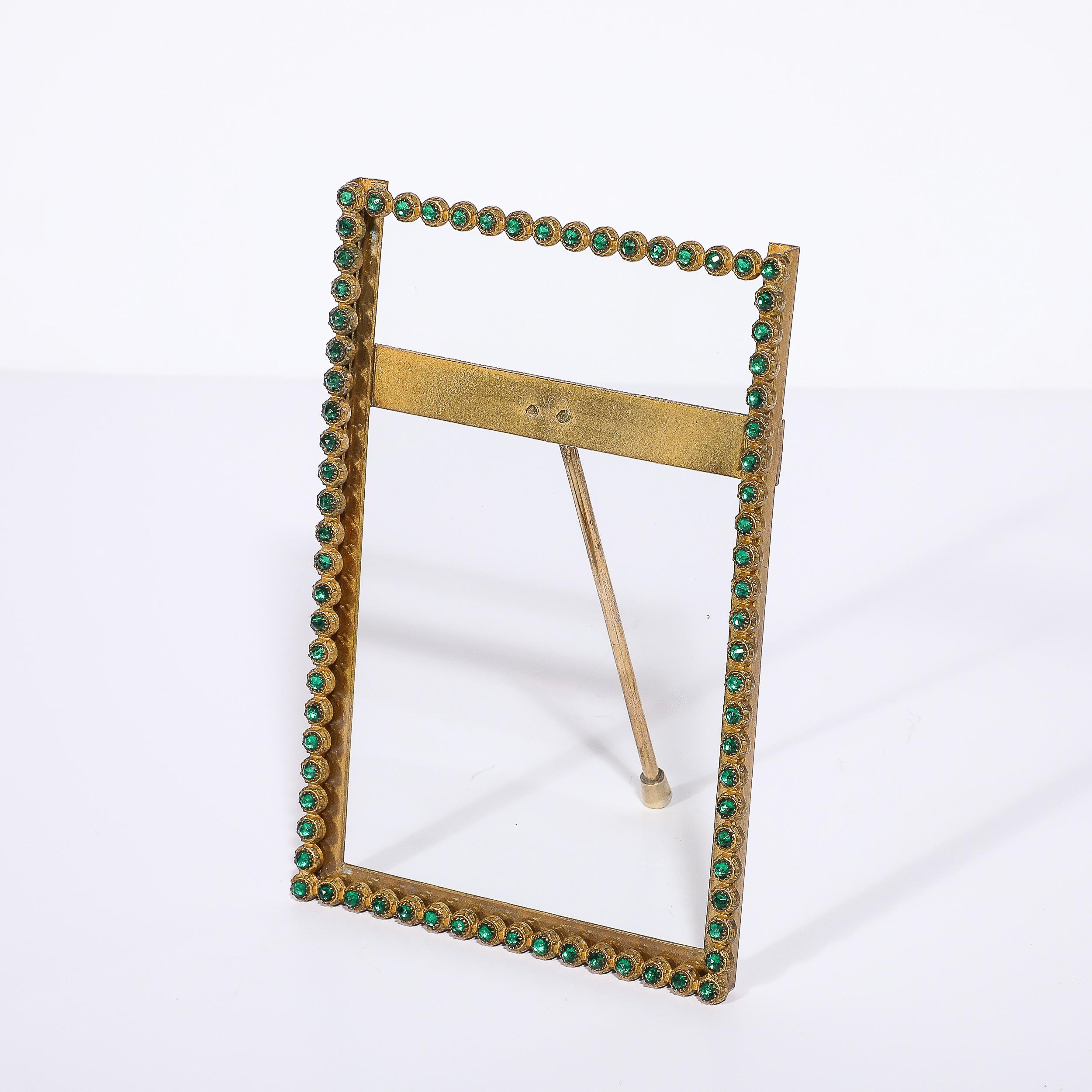 This well adorned and finely crafted Arts and Crafts Movement Green Gemstone Encrusted Picture Frame originates from France, Circa 1920. Featuring a lovely brass border with rounded settings containing green gemstones, glittering with an elegant