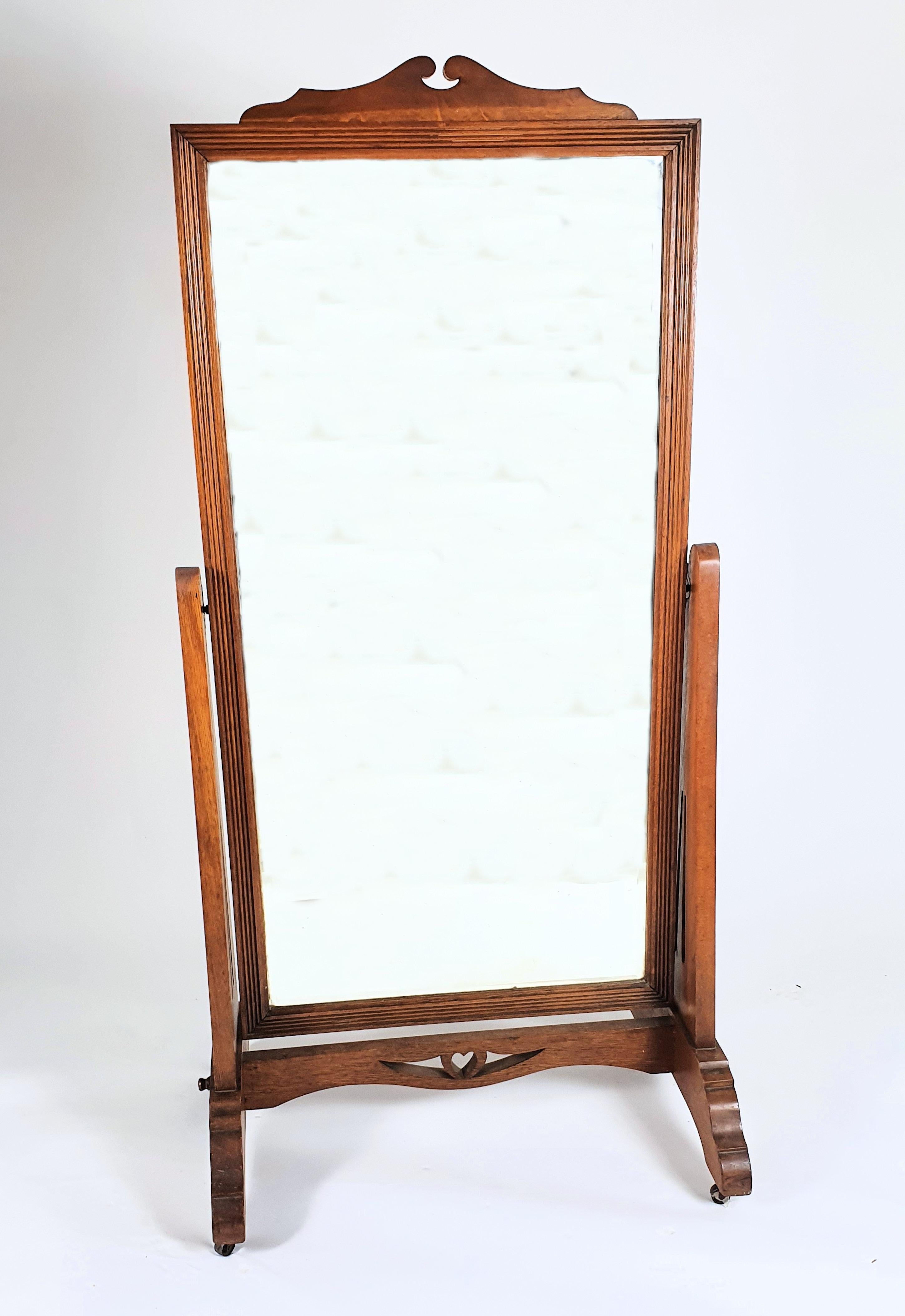 This very attractive and charming Arts & Crafts oak chevalier mirror features a pierced heart shaped decoration on the base support and is supported on castors. It measures 31 in – 78.6 cm wide, 22 in – 56 cm deep and 62 ½ in – 158.8 cm in height.
