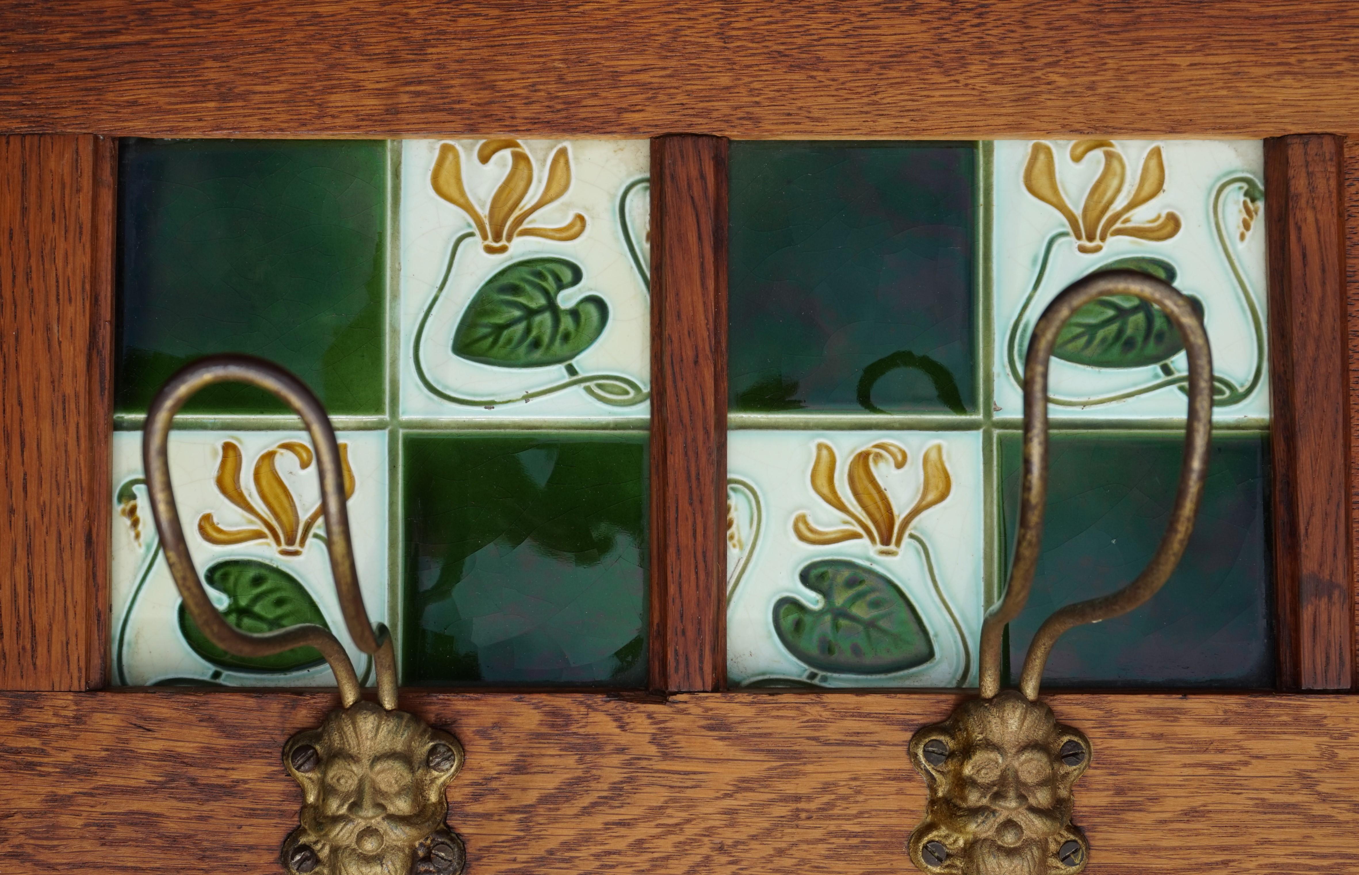 20th Century Arts & Crafts Oak Coat Rack with Majolica Glazed Lily Flower Tiles & Brass Hooks For Sale