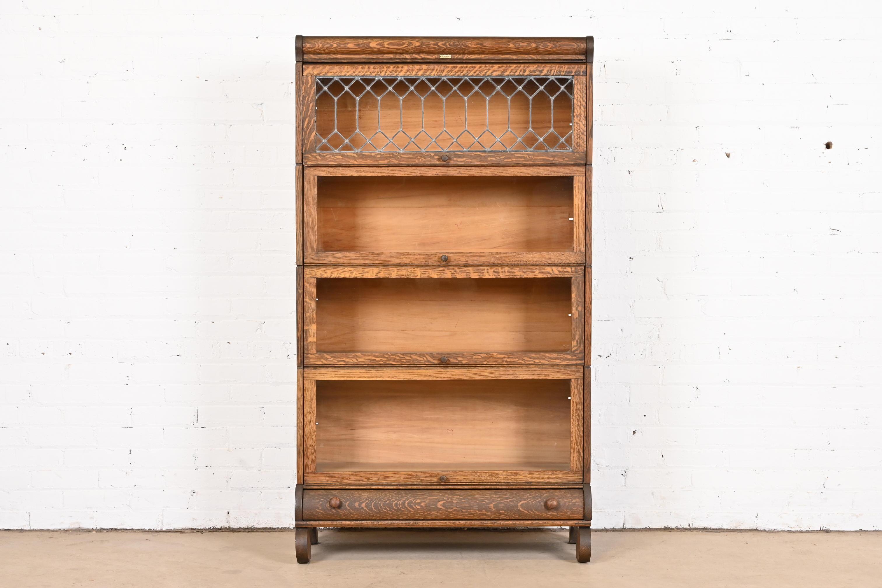 A gorgeous antique Arts & Crafts four-stack barrister bookcase with leaded glass

By Lundstrom

USA, circa 1900

Quartersawn oak, with glass front doors.

Measures: 33.75