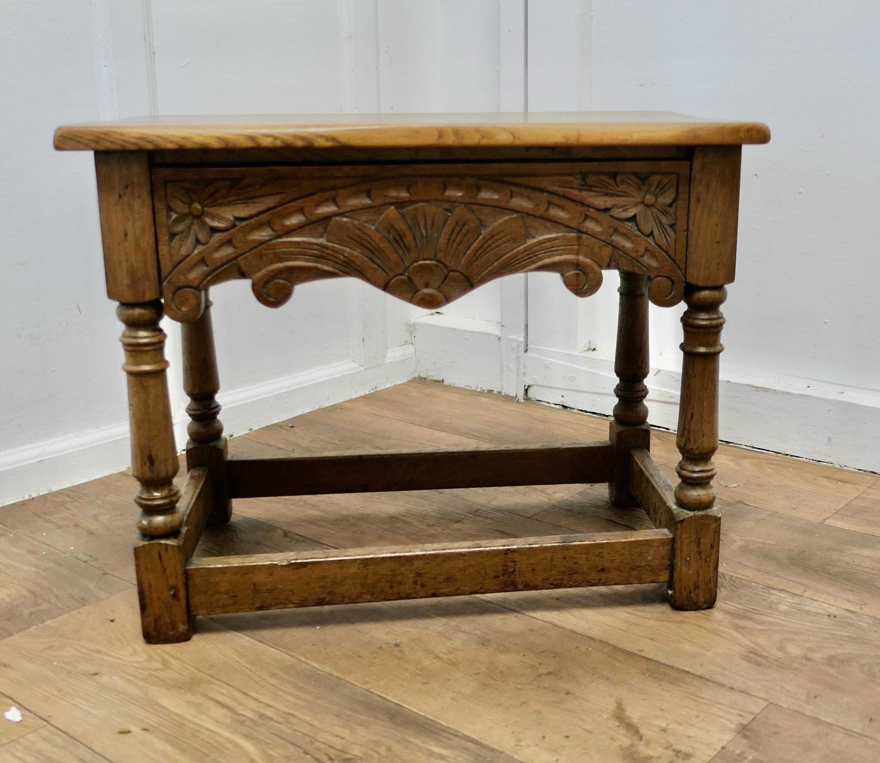 Arts and Crafts Oak Joint Stool, Occasional Table with Drawer

This a good Golden Oak Joint or Joined Stool with a carved frieze which is a drawer for storage 
This is a good solid stool, in good condition with a good colour
The stool is 19” high,