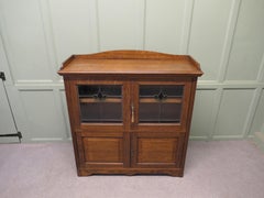 Arts and Crafts Oak Stained Glass Bookcase. A Charming 4 door glazed cupboard