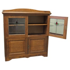 Arts and Crafts Oak Stained Glass Bookcase. A Charming 4 door glazed cupboard