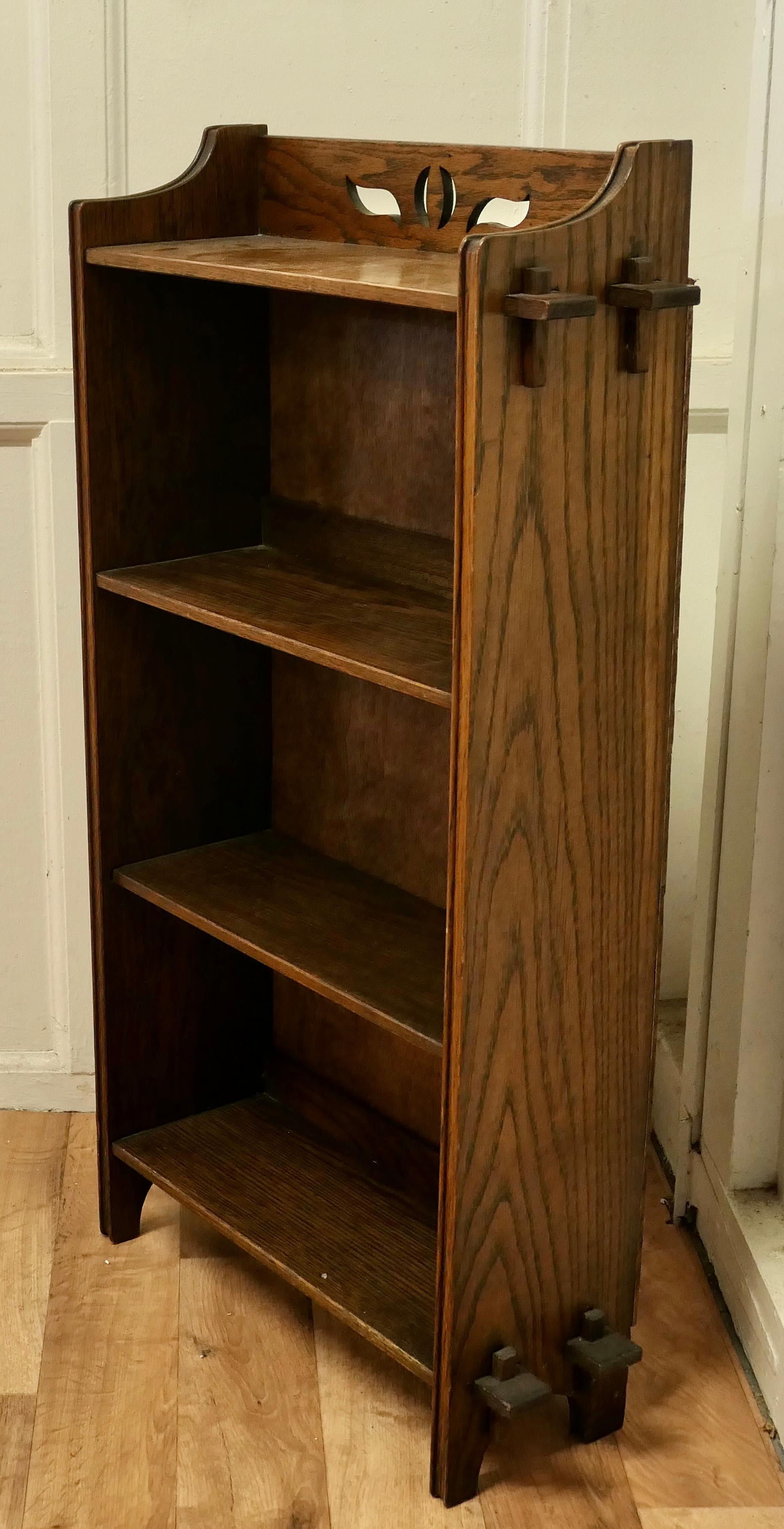 Arts and Crafts Open Front Oak bookcase.

This Oak bookcase has 4 shelves, the top has a neat pierced gallery and it stands on a pegged base
The bookcase is in good attractive condition and would work very well in your Living room, Office or