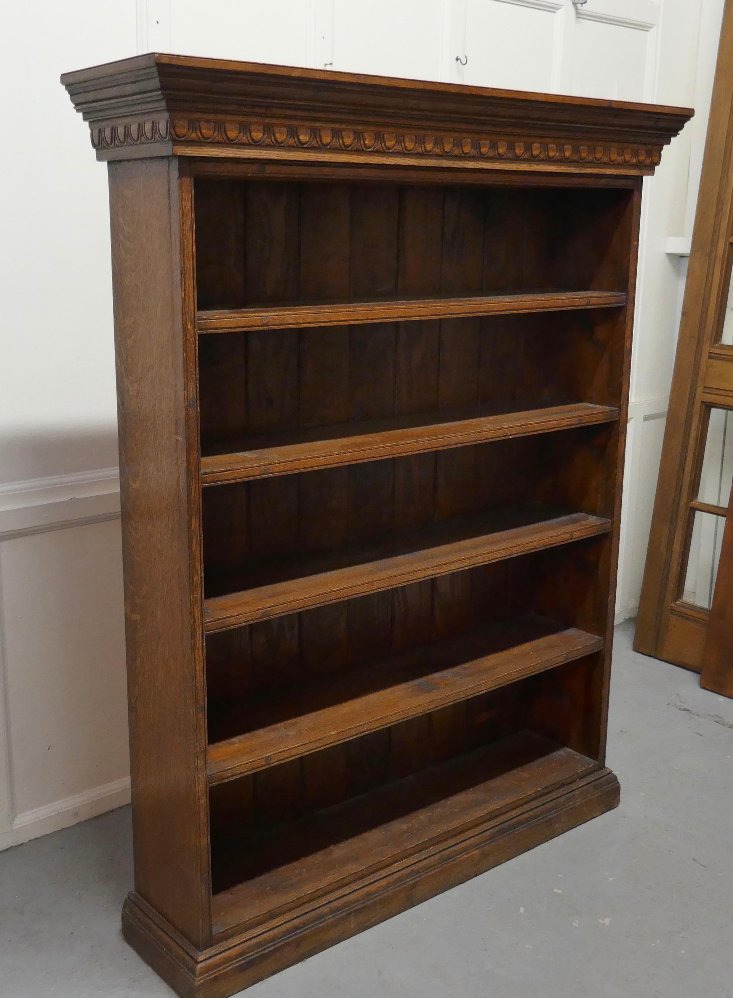 Arts and Crafts open oak bookcase with secret compartment

This oak bookcase has reeded fronts to the shelves and sides, it stands on a neat plinth with large carved cornice at the top
The bookcase is in good attractive condition
This one hides