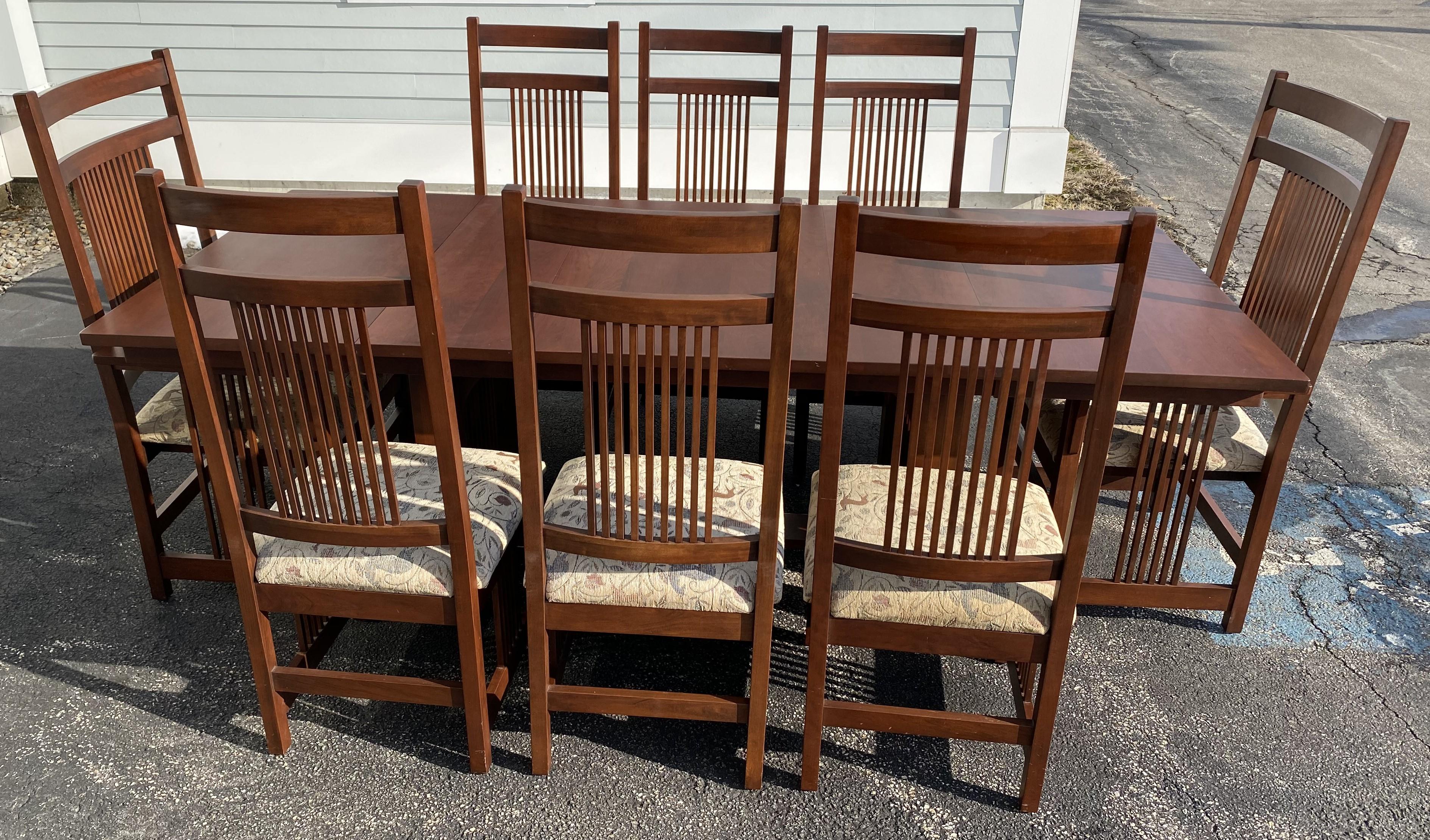 A fine quality Arts and Crafts or Mission style cherry dining set from Canal Dover Furniture in Midvale, Ohio, including a rectangular dining table, expandable with two additional leaves, and eight dining chairs (2 arm chairs and 6 side chairs),