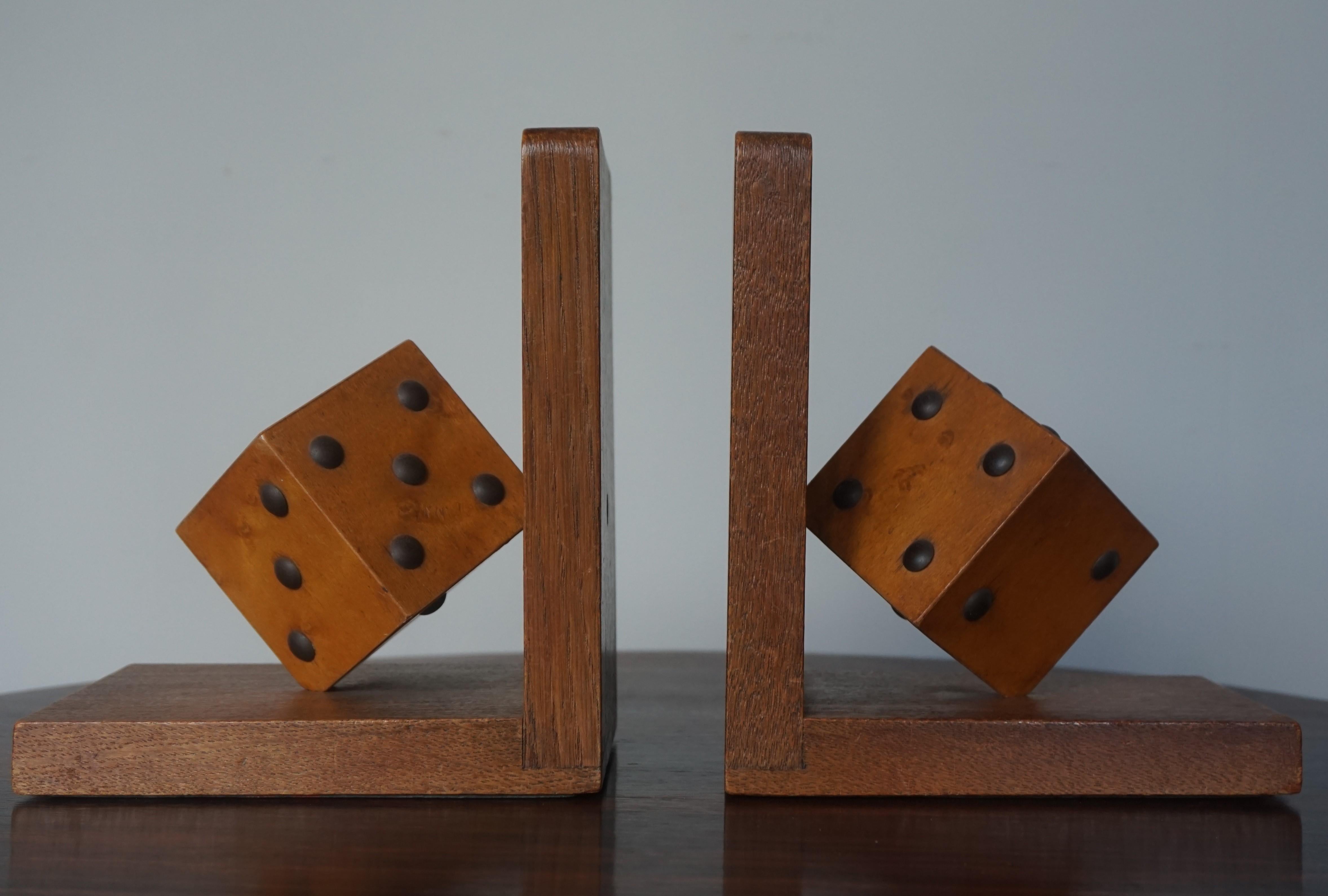 Rare and highly decorative pair of antique bookends for the gambling man.

These handcrafted bookends from the earliest years of the twentieth century are practical in size and they come with a beautiful pair of dice made of nutwood and metal nails.