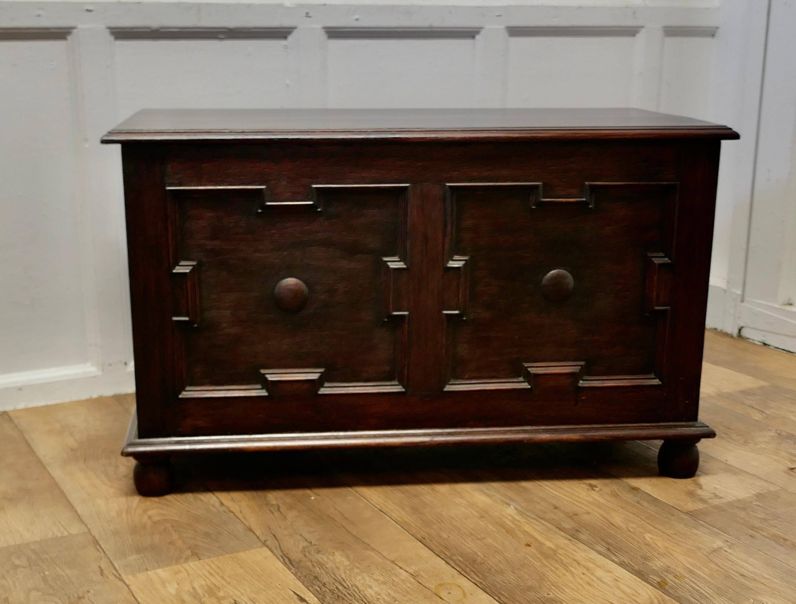 Arts and Crafts Panelled Oak Coffer 

This is a lovely piece, with a good patina, the chest has two panels on the front, these have a geometric border with a centre dome 
The sides of the chest have moulded panels and the chest is set on a neat