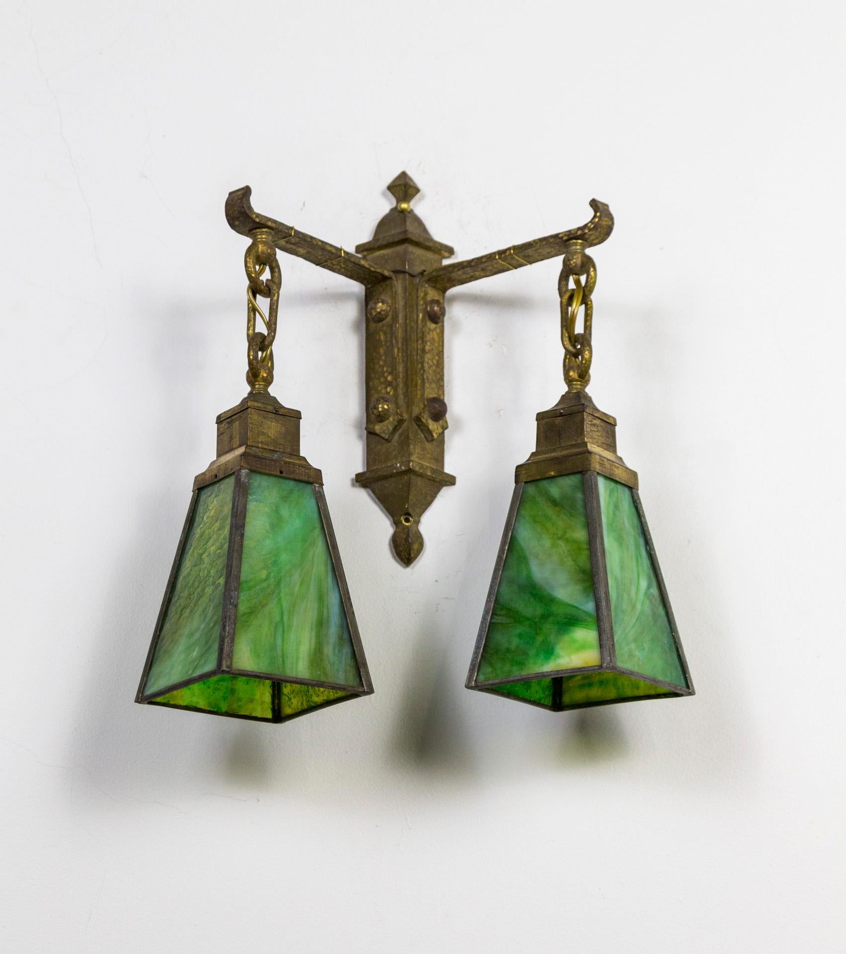 Craftsman Style, Arts & Crafts Period, 2-Light sconce with green, slag glass shades. Rustic and charming. Hand hammered, brass back plate with hand made details. Four sided shades in striking green, leaded art glass panels. 1920s, USA. Newly wired