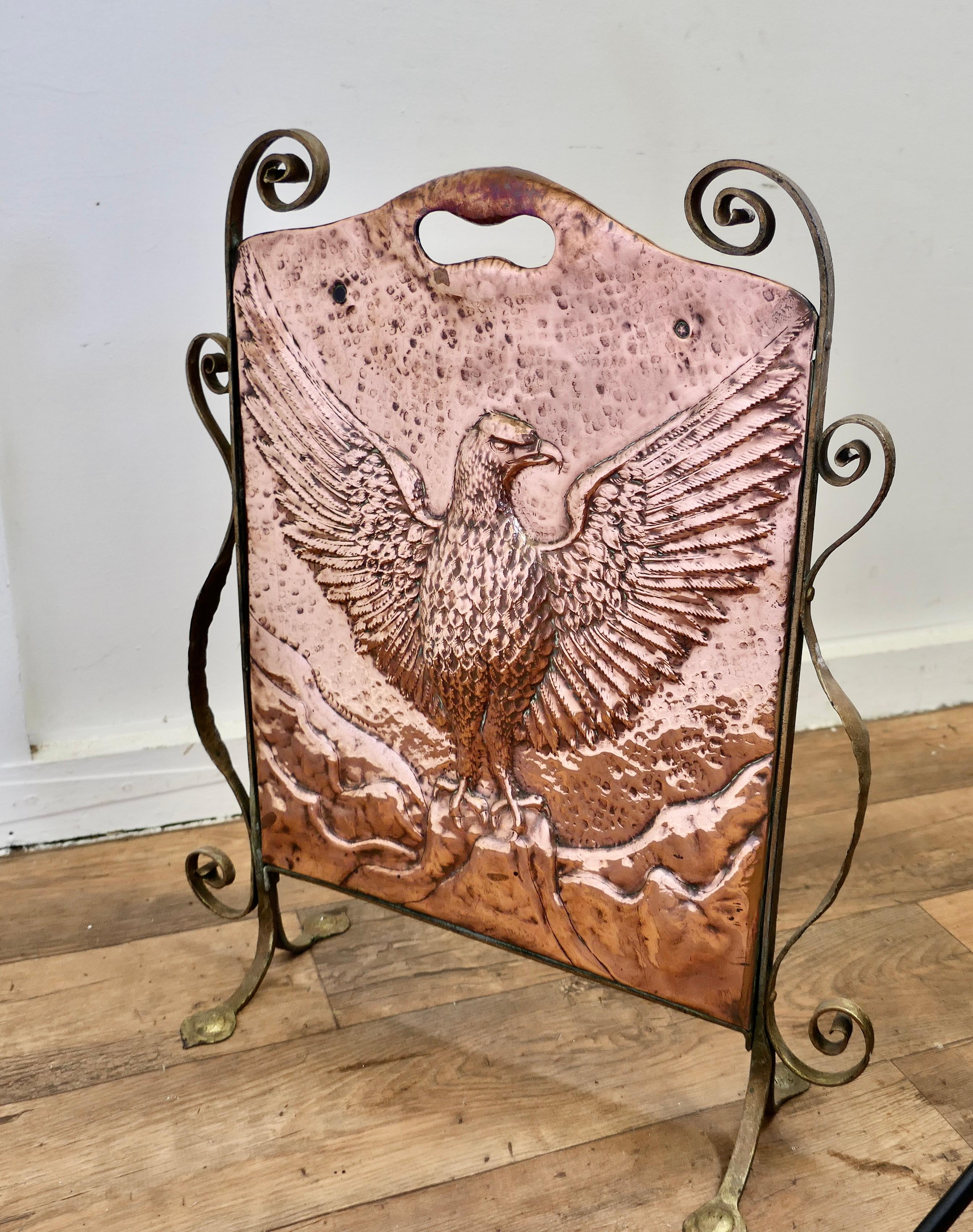 Arts and Crafts Phoenix Eagle Copper and Brass Fire Screen

This is a Classic in the Arts and Crafts Style, it is a hand beaten copper screen, which is mounted on a very stylish brass frame 

The centre of the screen shows an Eagle or Phoenix about