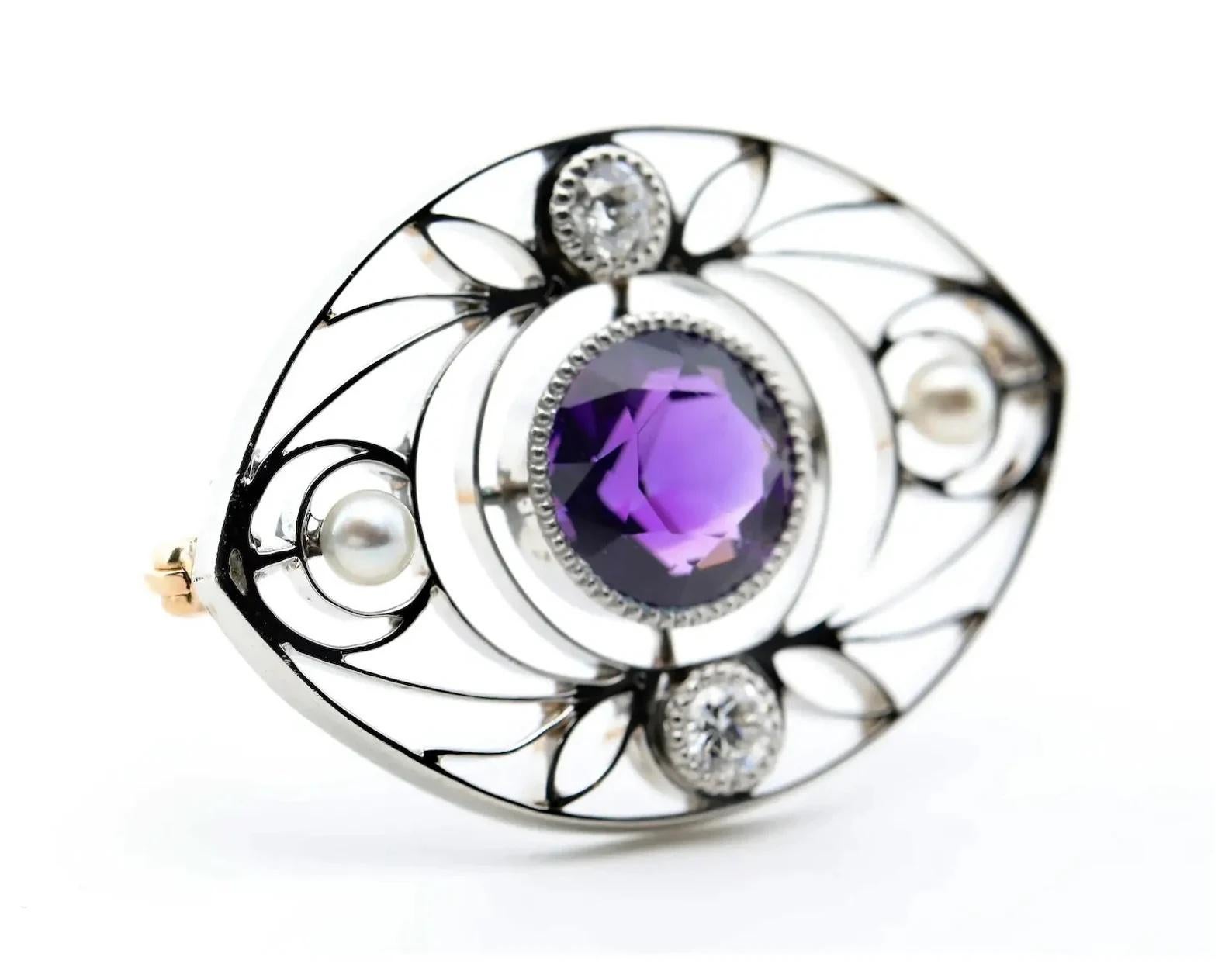 An Art Nouveau period amethyst brooch accented by natural pearls and European cut diamonds in a wire work mounting.

Weighing 2.50 carats, the center amethyst is of rich vivid purple color and sits in a miligrained bezel setting.

Two old European