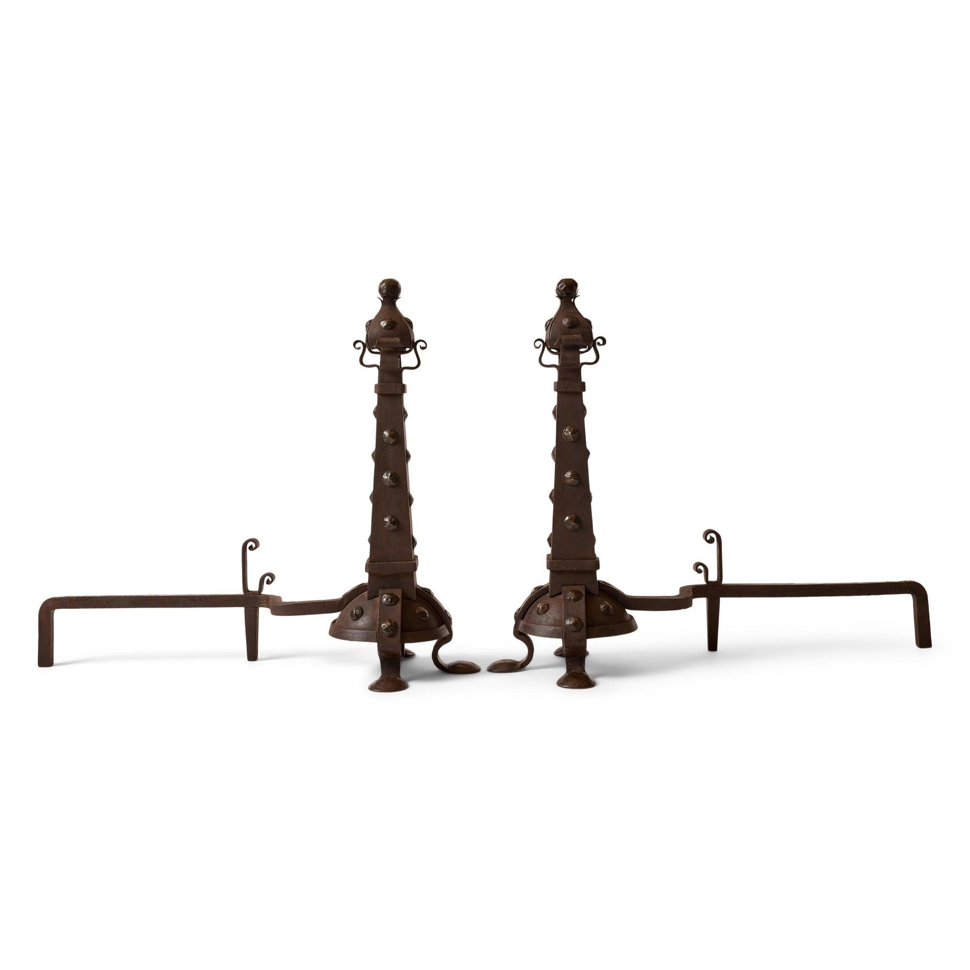 Large scaled hand wrought iron columns with riveted legs and hammered domed feet.
