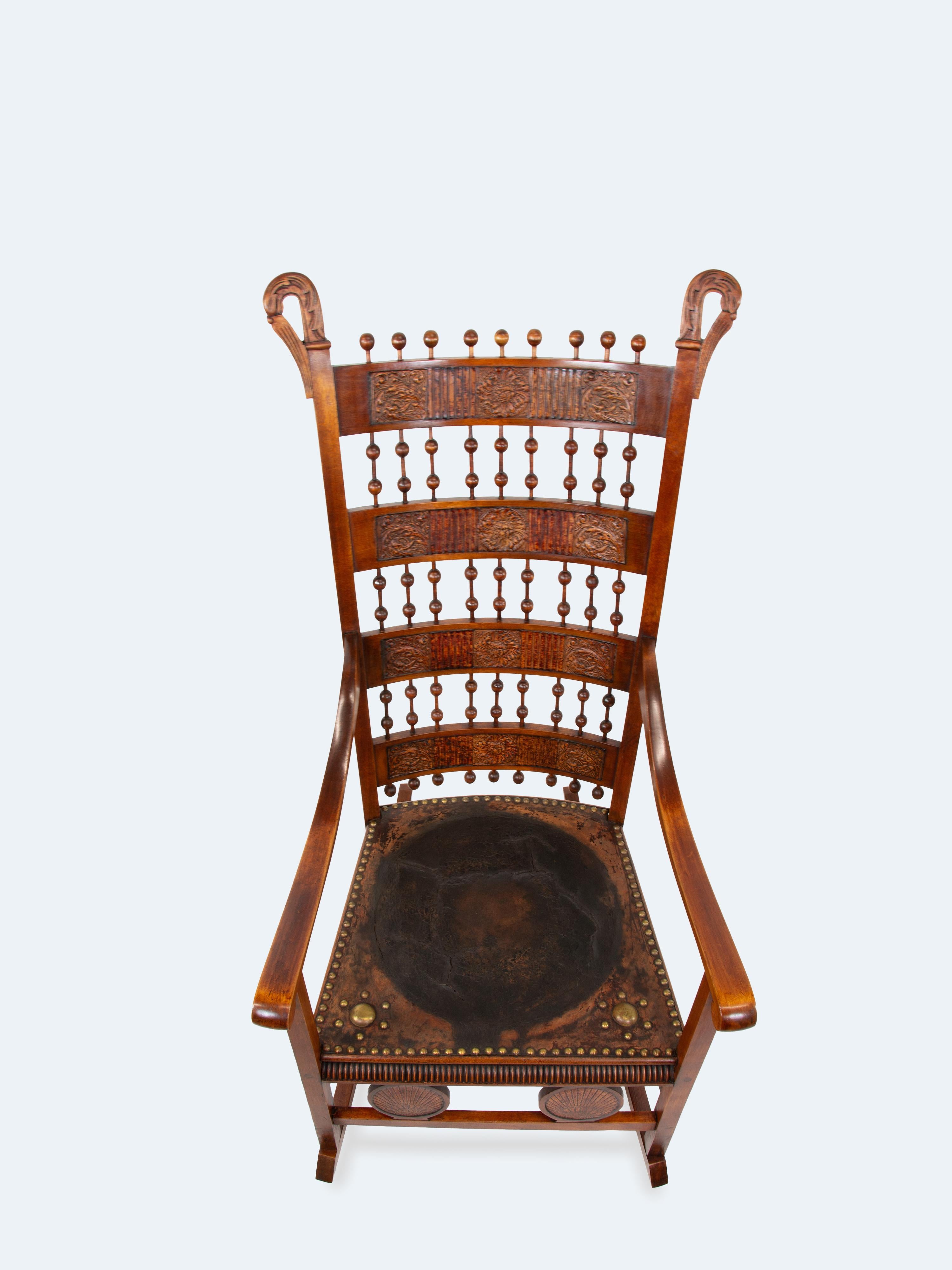 This late 19th-century Arts and Crafts rocking chair is a striking example of the movement’s dedication to craftsmanship and functional beauty. Widely found in the UK and Scandinavia, this chair features a beautifully crafted backrest with