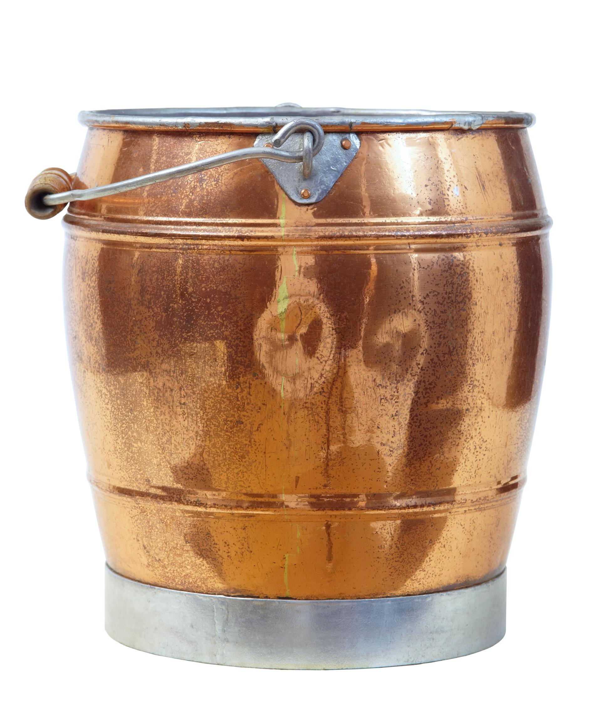 Arts & Crafts Scandinavian copper bucket circa 1890.

Fine quality keg shaped copper bucket. Steel rim base and handle with turned pine handle. Ideal for use as a log bin or quirky waste paper basket.

Expected surface marks and fading.