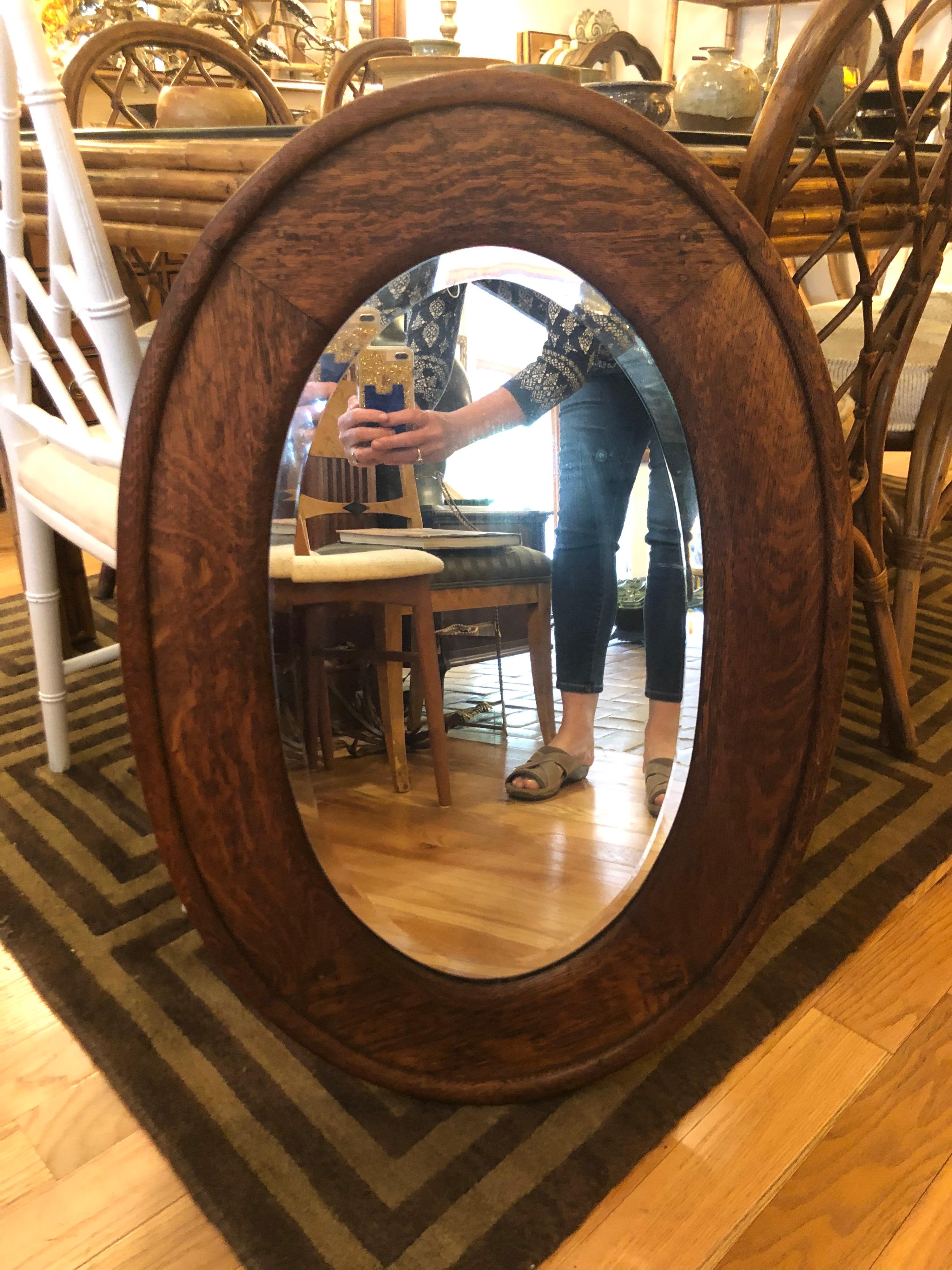 Arts and Crafts solid oak oval mirror. Nice thick one inch bevel to this beauty. Perfect for a powder room or smaller space. Ready top hang.